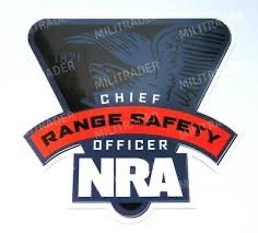 NRA Range Safety Officer badge with black cap, red and white lettering, and NRA logo