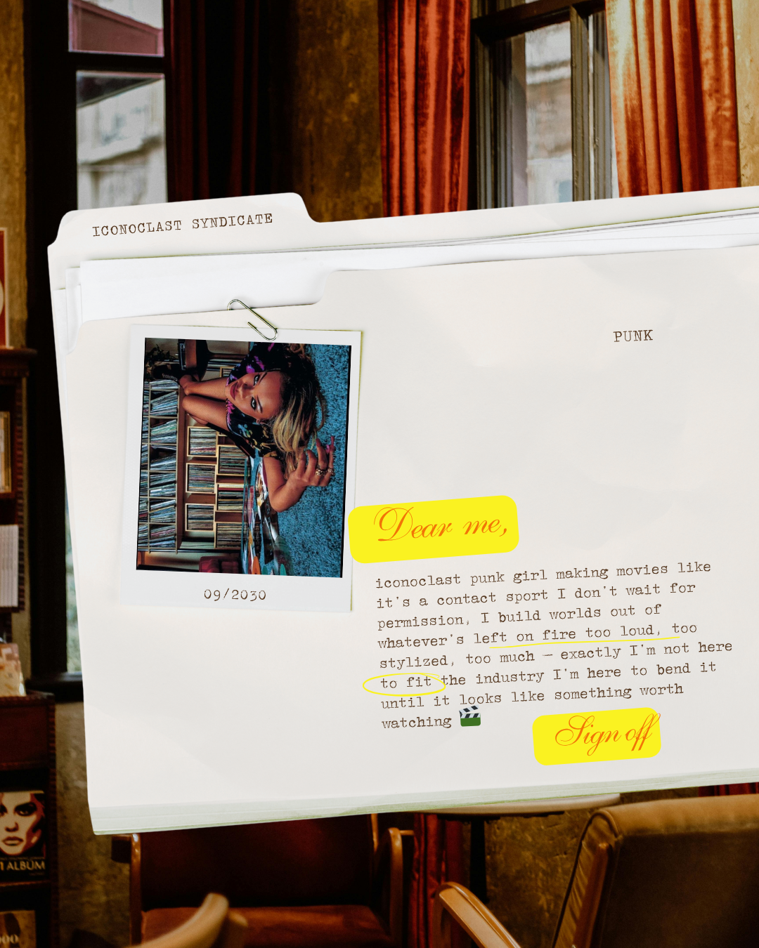 A desk with a large file folder labeled "ICONOCLAST SYNDICATE" and a photo pinned to it. The photo shows a woman with blond hair lying on the floor, surrounded by shelves of CDs in a music store or library. The folder has the word "PUNK" written on i