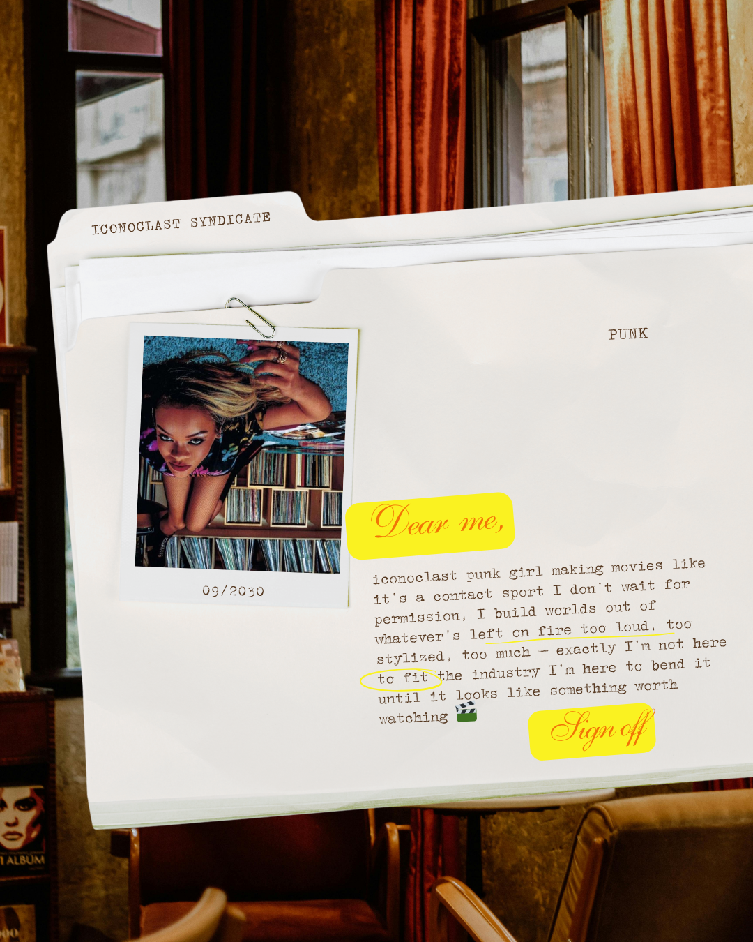 A white folder labeled 'ICONOCLAST SYNDICATE' with a photograph of a woman on a shelf in the background. The folder has typed text with highlighted words and a small emoji of a film camera, including phrases like 'Dear me,' and 'sign off.'