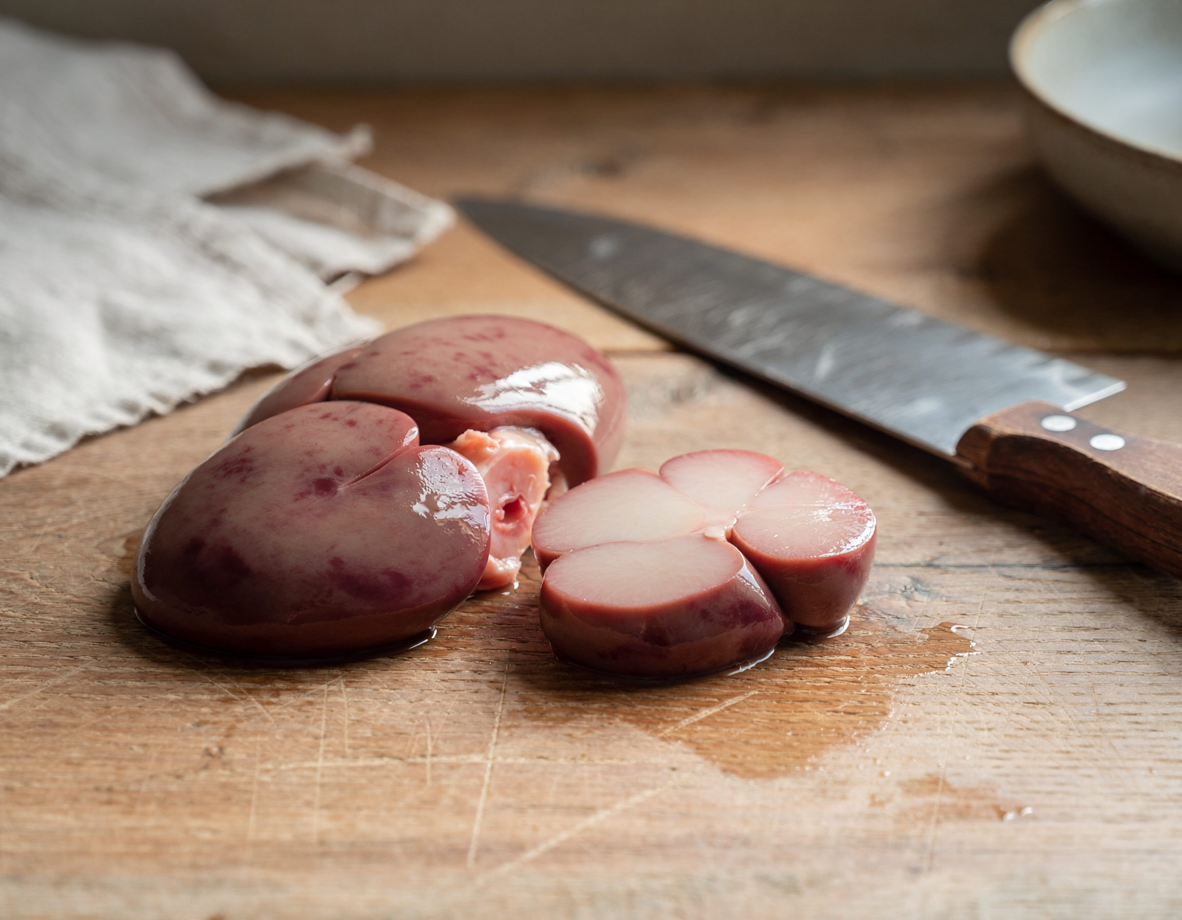 Firefly_fresh butchered lamb kidney on a table 450636.png