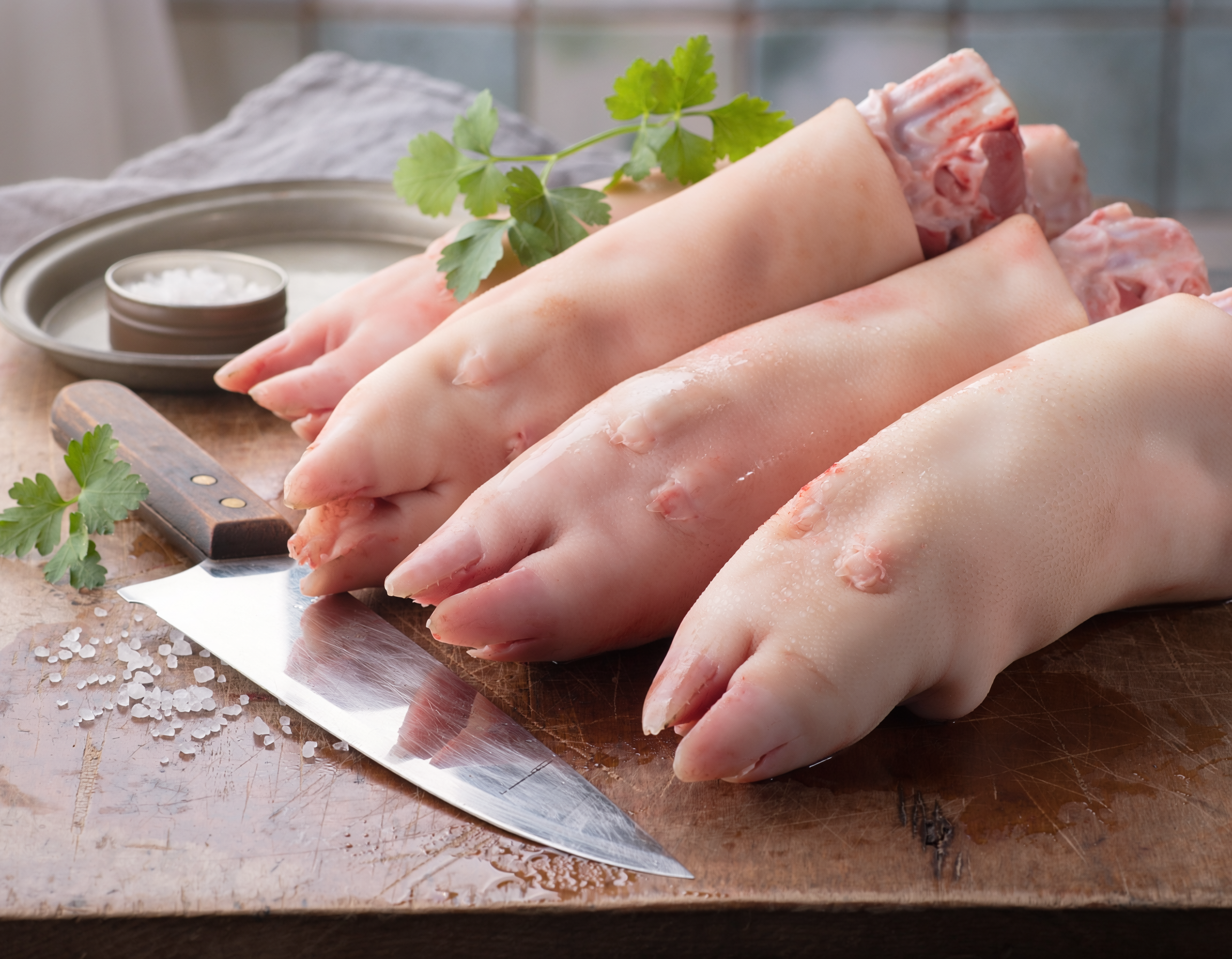 Firefly_fresh butchered pig feet on a table 147004.png