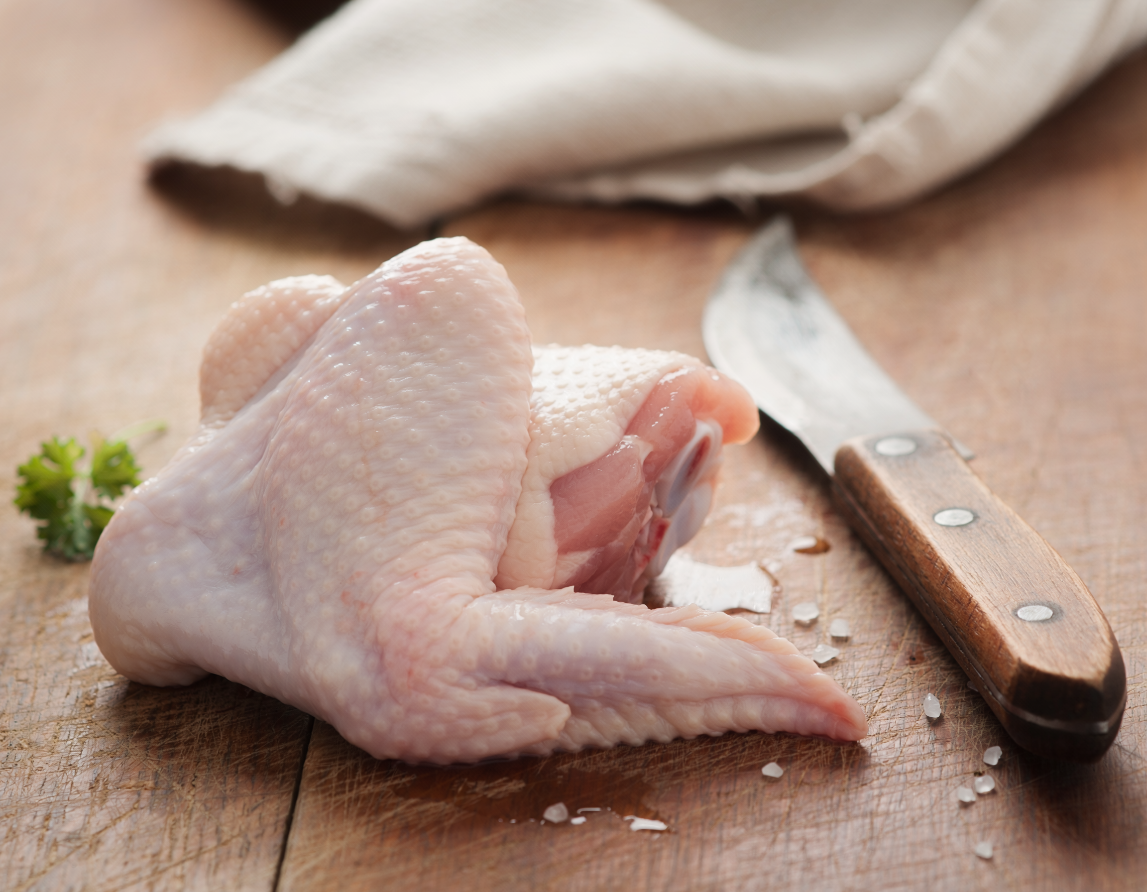 Firefly_fresh butchered bone-in chicken wing on a table 147004.png