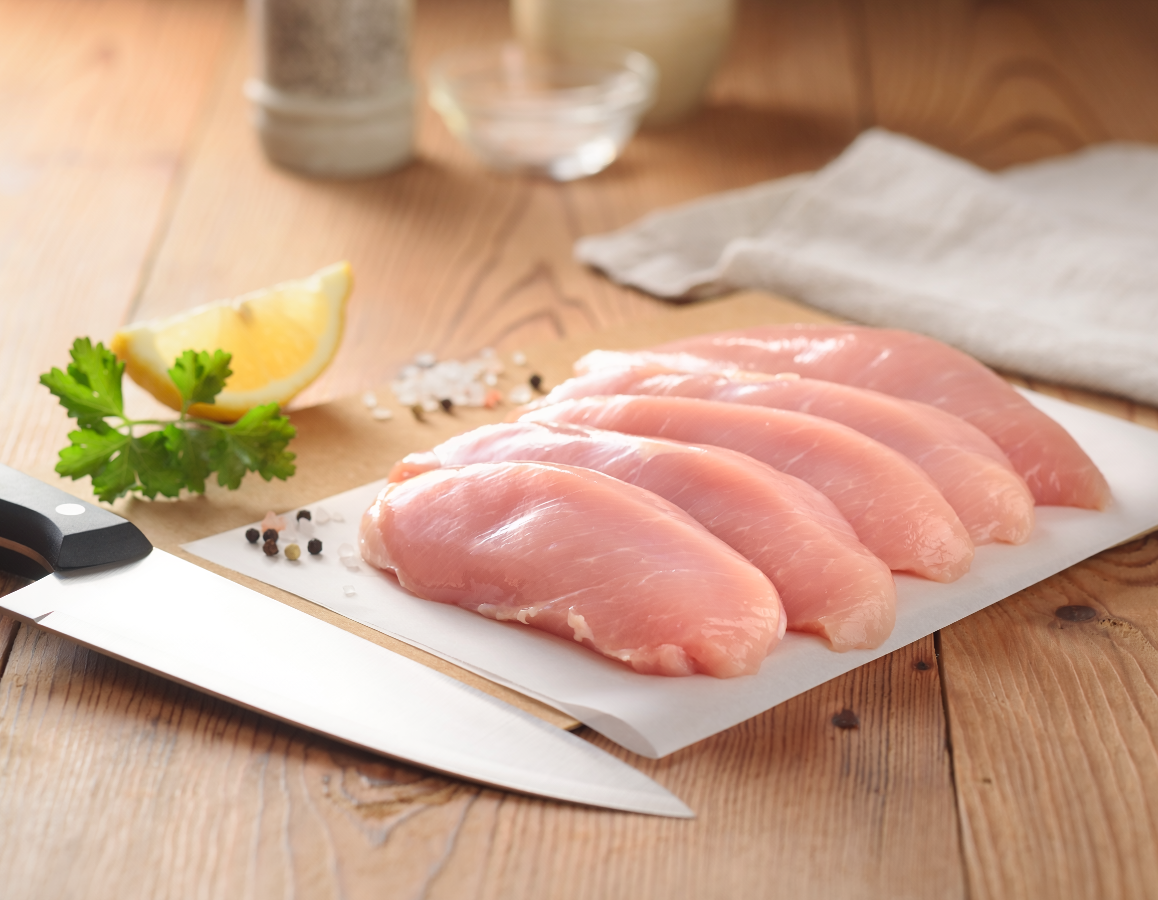 Firefly_fresh butchered chicken tenderloin on a table 147004.png