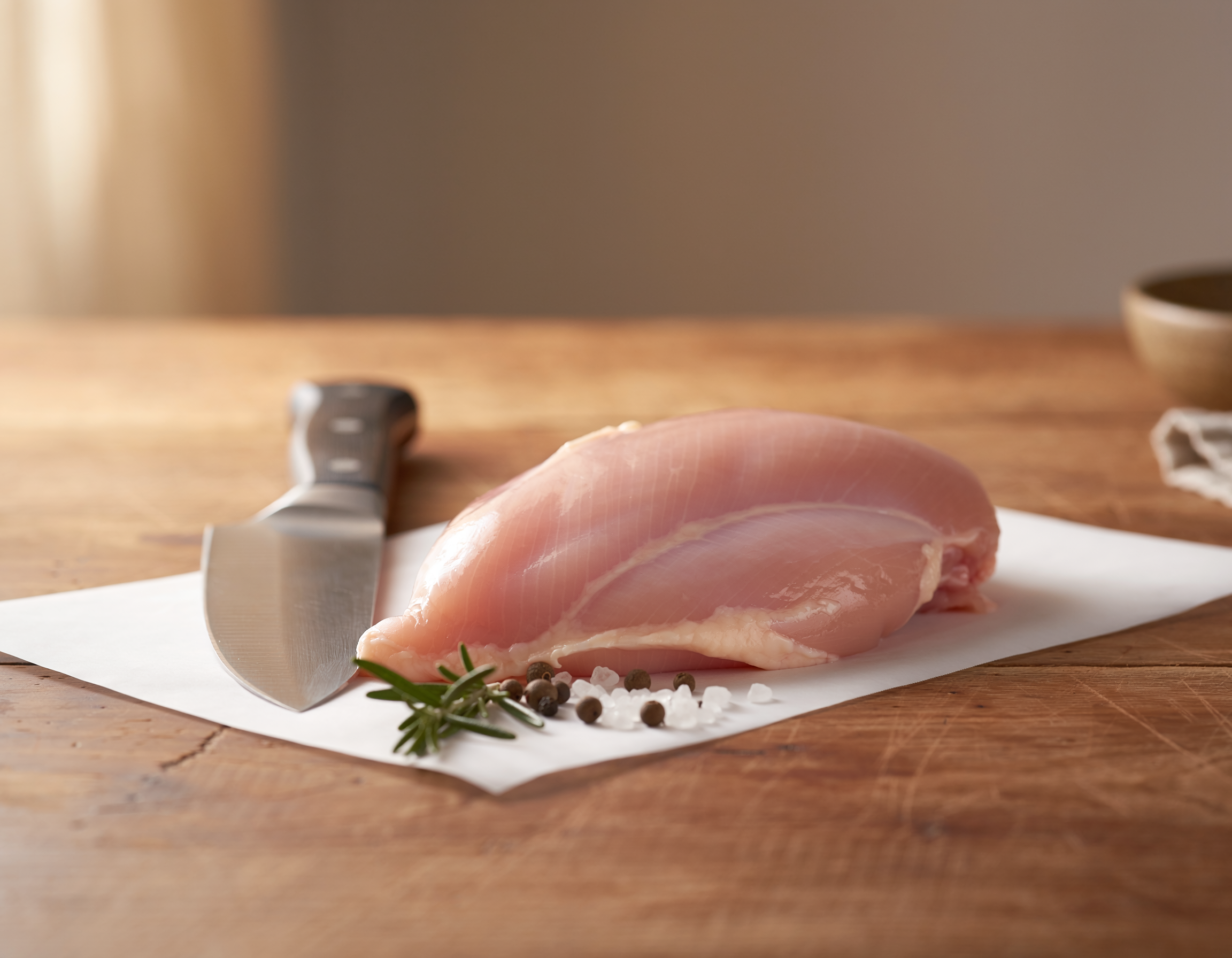 Firefly_fresh butchered boneless skinless chicken breast on a table 147004.png