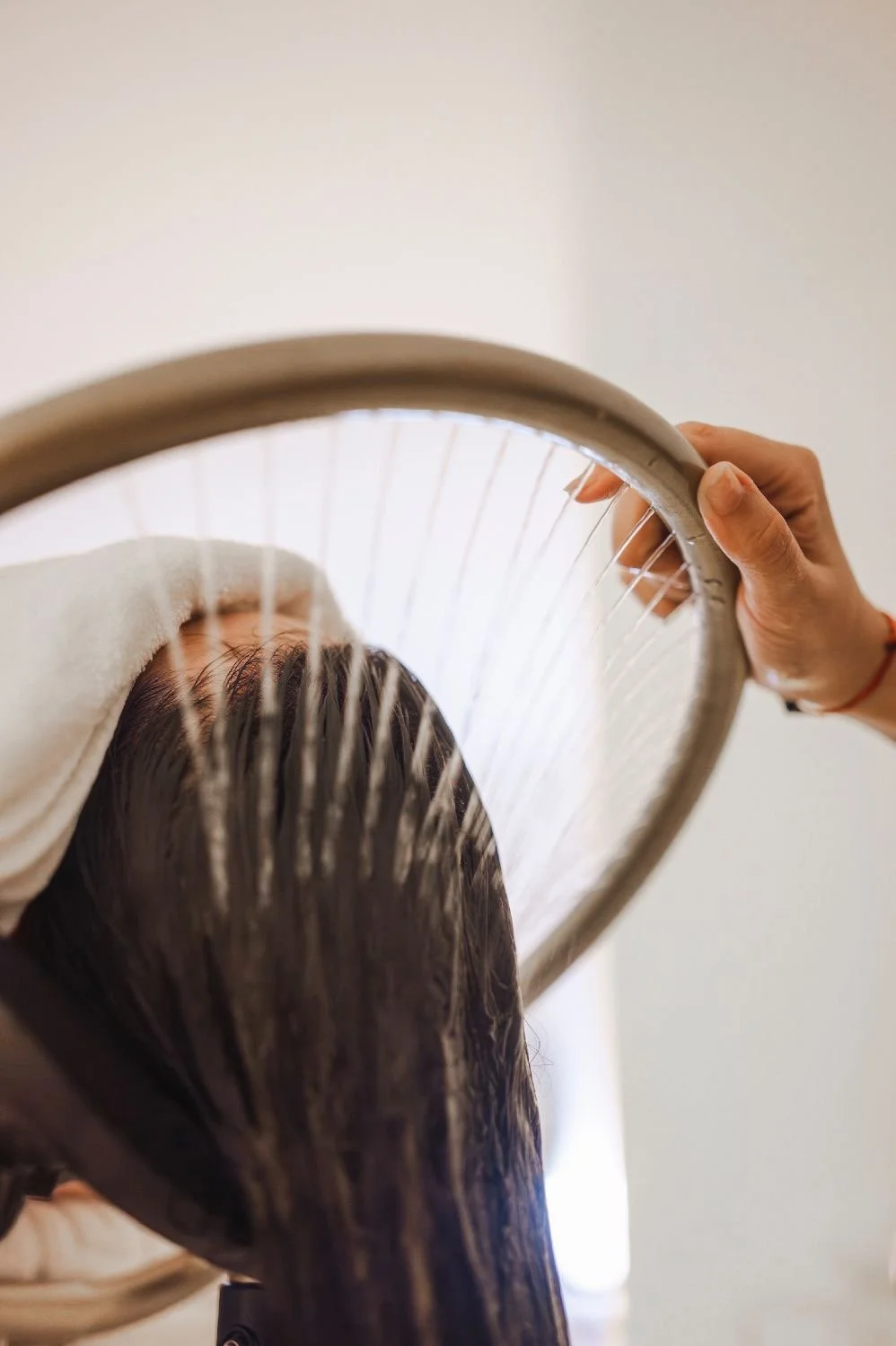 A person receiving a scalp treatment where their hair is being washed by an Japanese scalp treatment device.