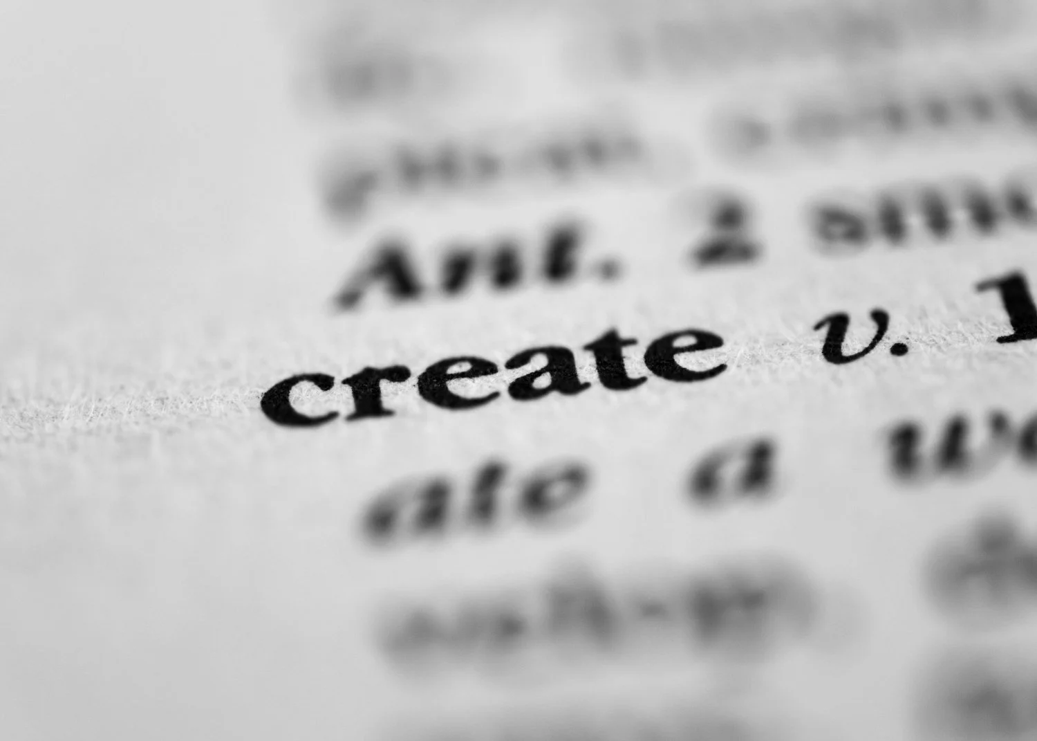 Close-up of printed text highlighting the word 'create' on a page.