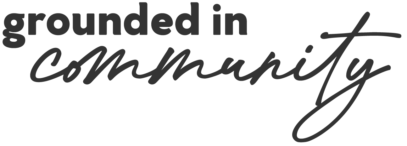 Text that reads 'grounded in community' in a combination of bold and cursive font styles.