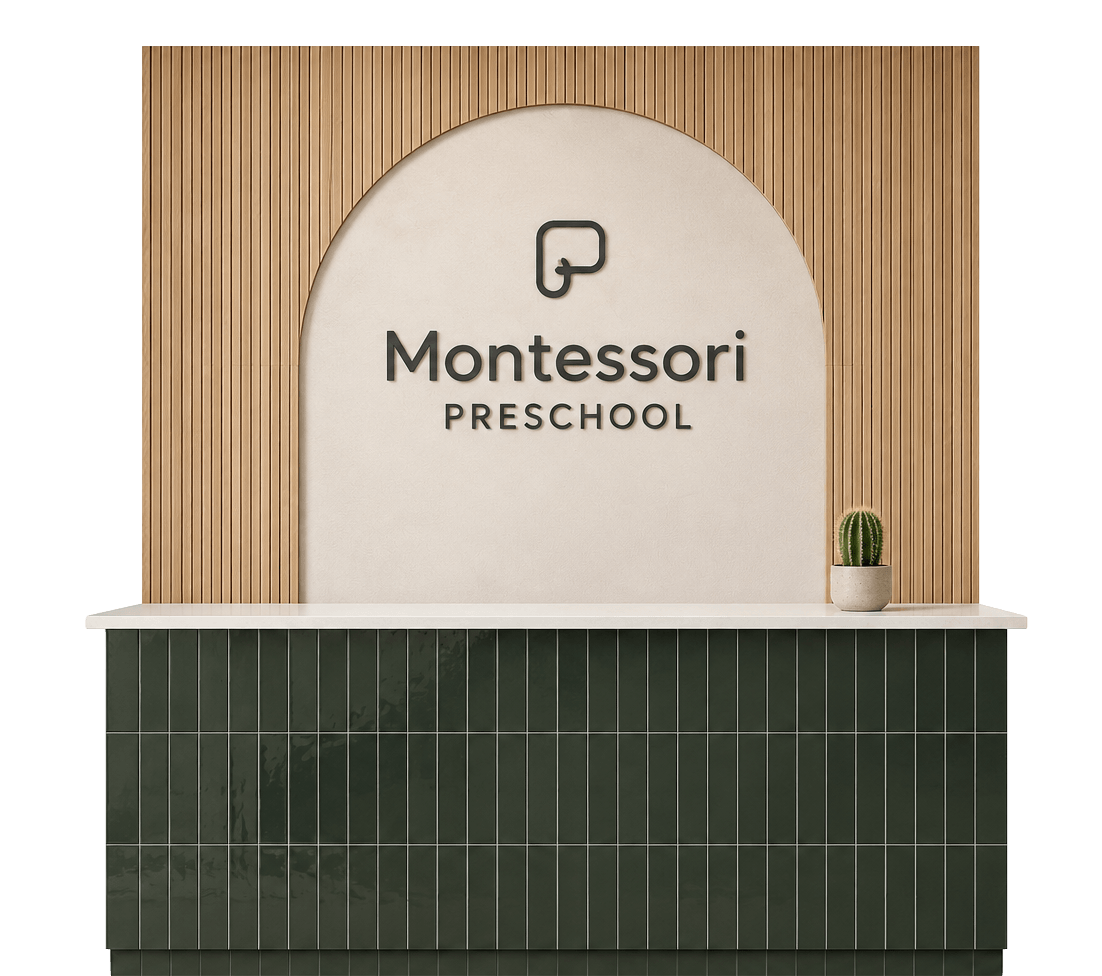 Reception desk at Montessori preschool with a cactus plant on it, behind a wall with wooden slats and a sign that reads "Montessori PRESCHOOL".