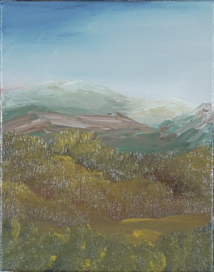 Rounded sage mountains under a stormy blue-gray sky above autumn foliage, left panel of a mountain triptych