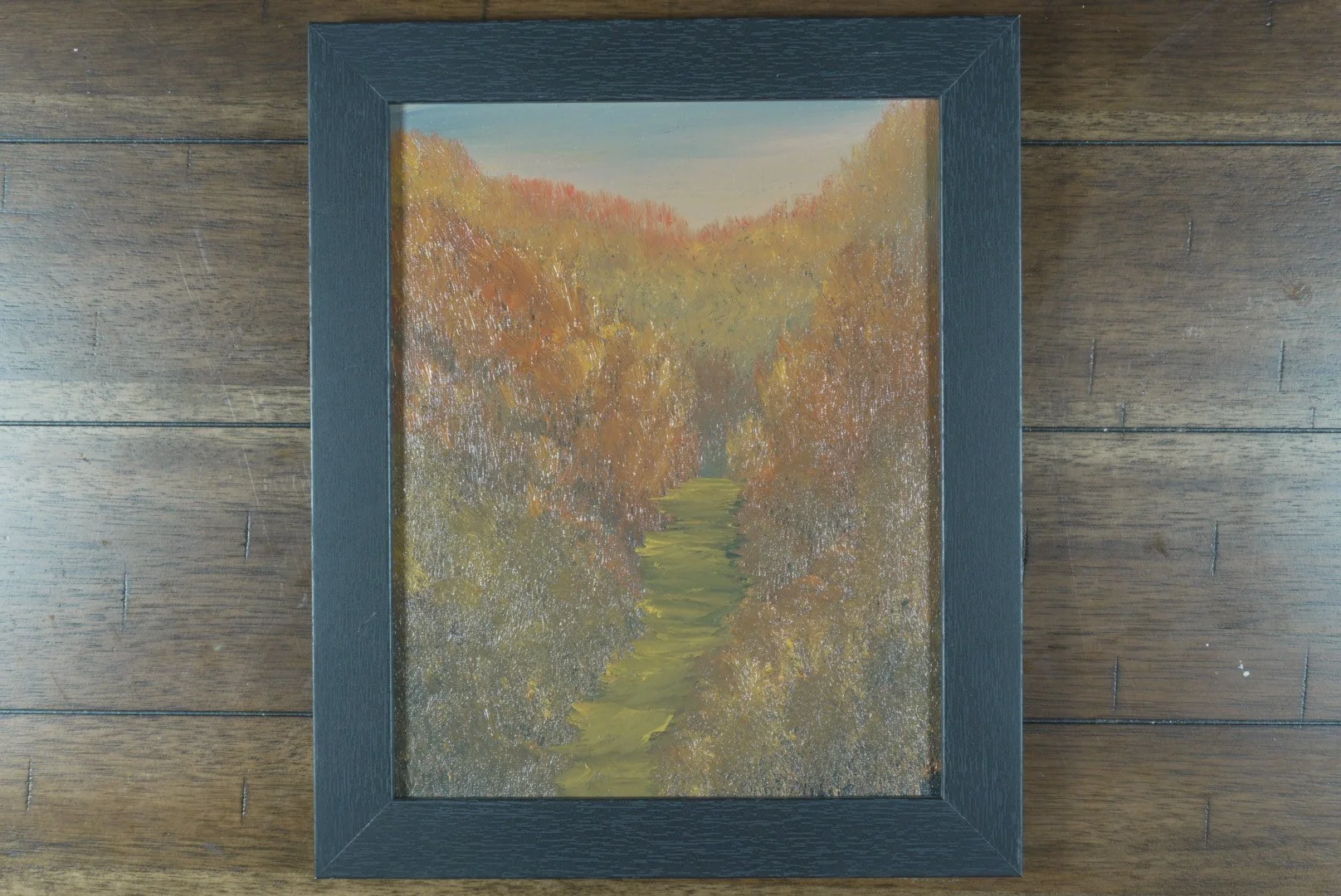 The Amber Hollow in a black wood frame
