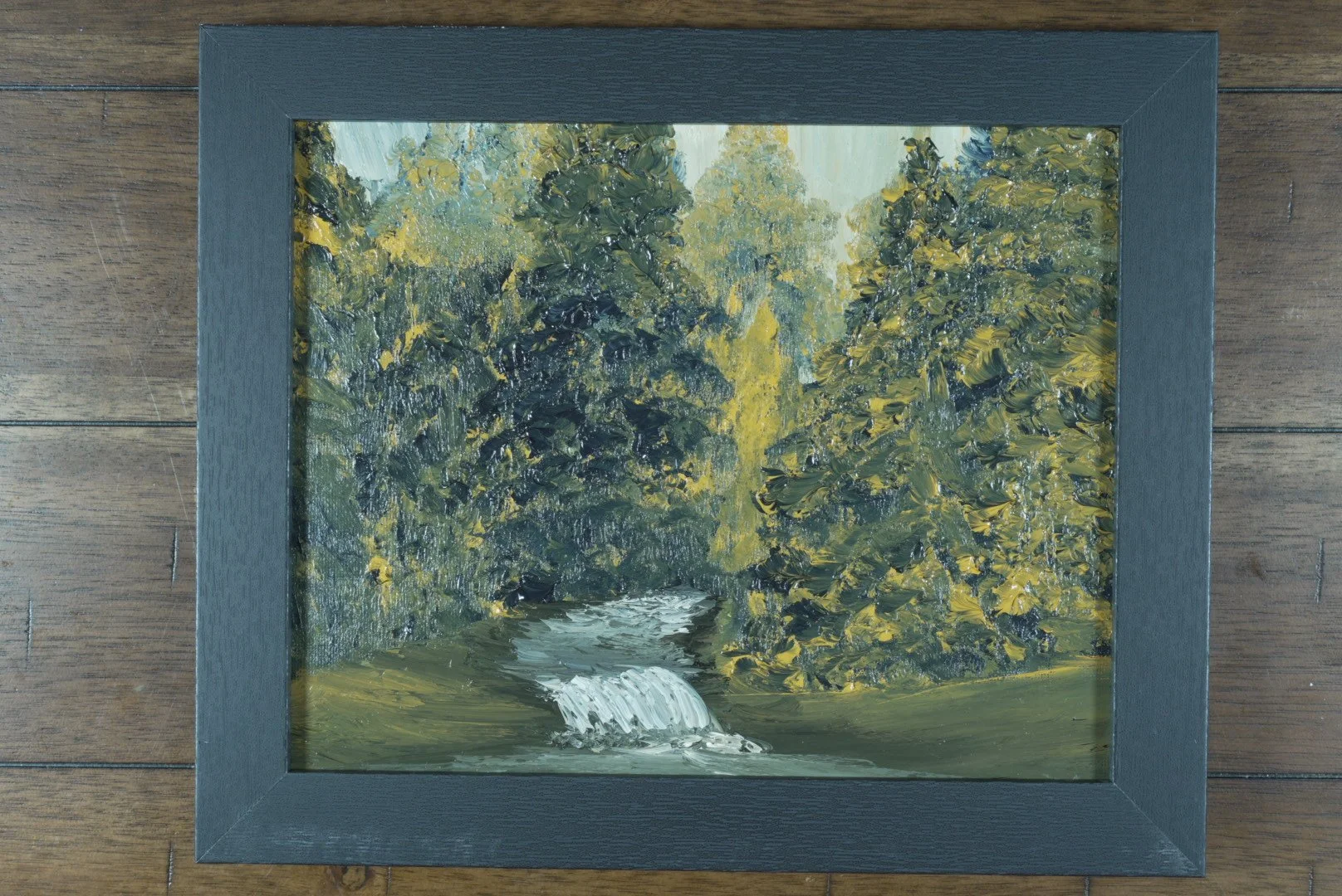 The Hidden Cascade in a black wood frame
