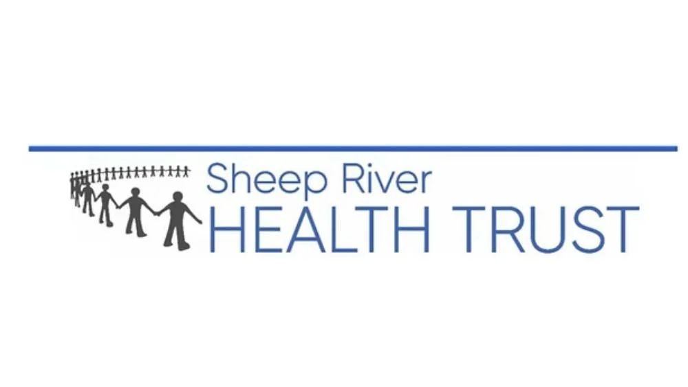 Logo of Sheep River Health Trust with stylized figures holding hands and a fence, written in blue text.