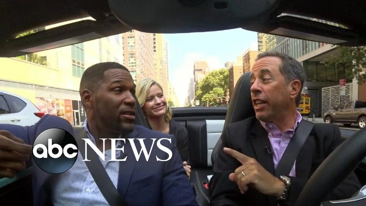 Three people chatting in a convertible car on a city street, with the 'abc News' logo overlaid on the left side of the image.