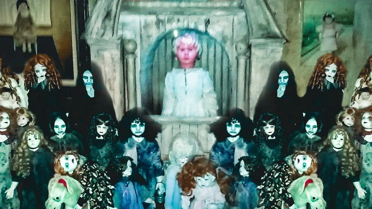 Children dressed as witches and ghosts, with some wearing masks, are gathered around a woman in a white dress seated on a throne-like chair in a room decorated for Halloween.