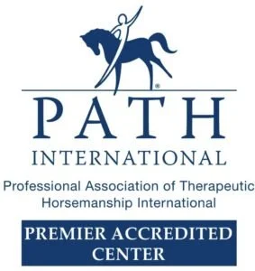 Logo of PATH International featuring a person riding a horse and holding a stick, with text indicating accreditation as a premier center.