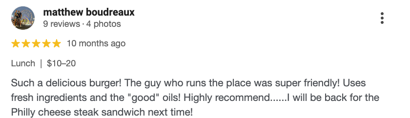 A restaurant review mentioning a burger, friendly staff, fresh ingredients, and a future visit for a Philly cheesesteak sandwich.