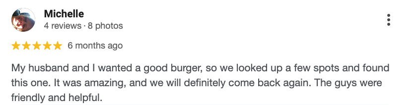 A restaurant review by Michelle mentioning a good burger and friendly staff.