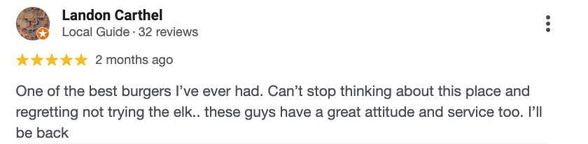 Screenshot of a Yelp review for Landon Carthel, a local guide with 32 reviews. The review gives five stars, written two months ago, praising the burgers and the attitude and service of the staff.