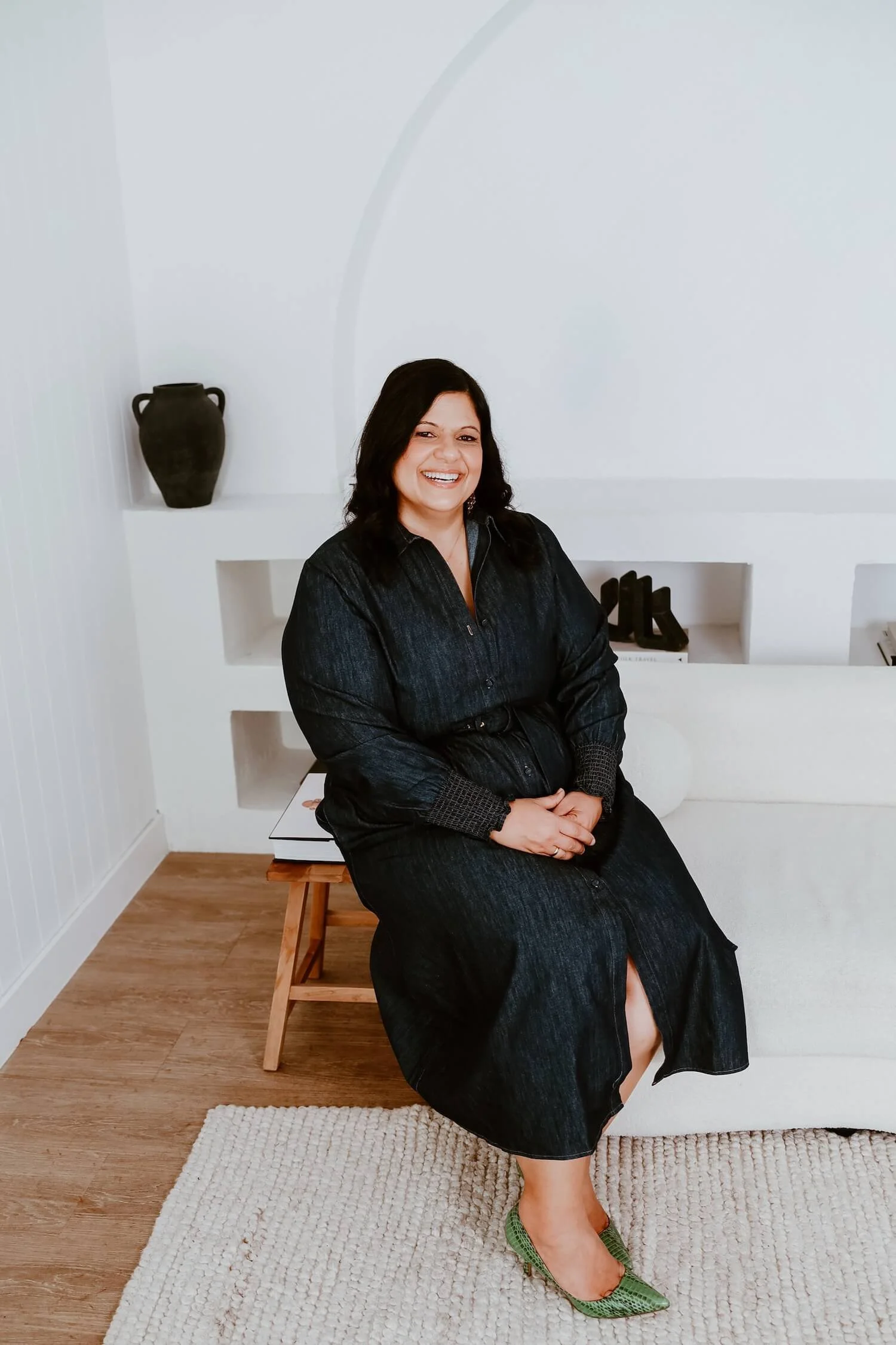 Alfina Lofaro, relationship coach and kinesiologist, seated in a warm and welcoming setting