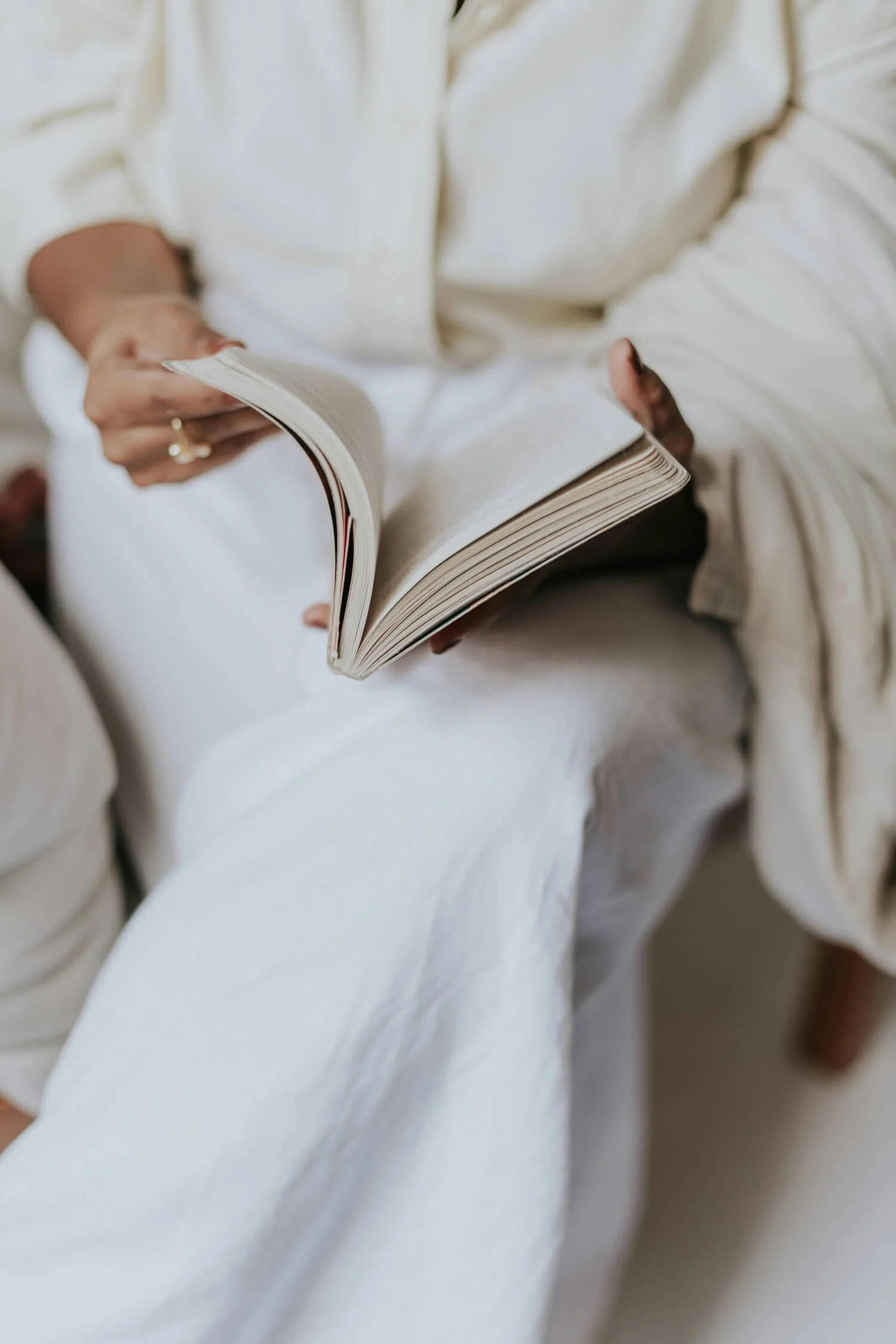 Woman sitting quietly reading a book, representing the reflective, self-paced journey of reading Love Deliberately