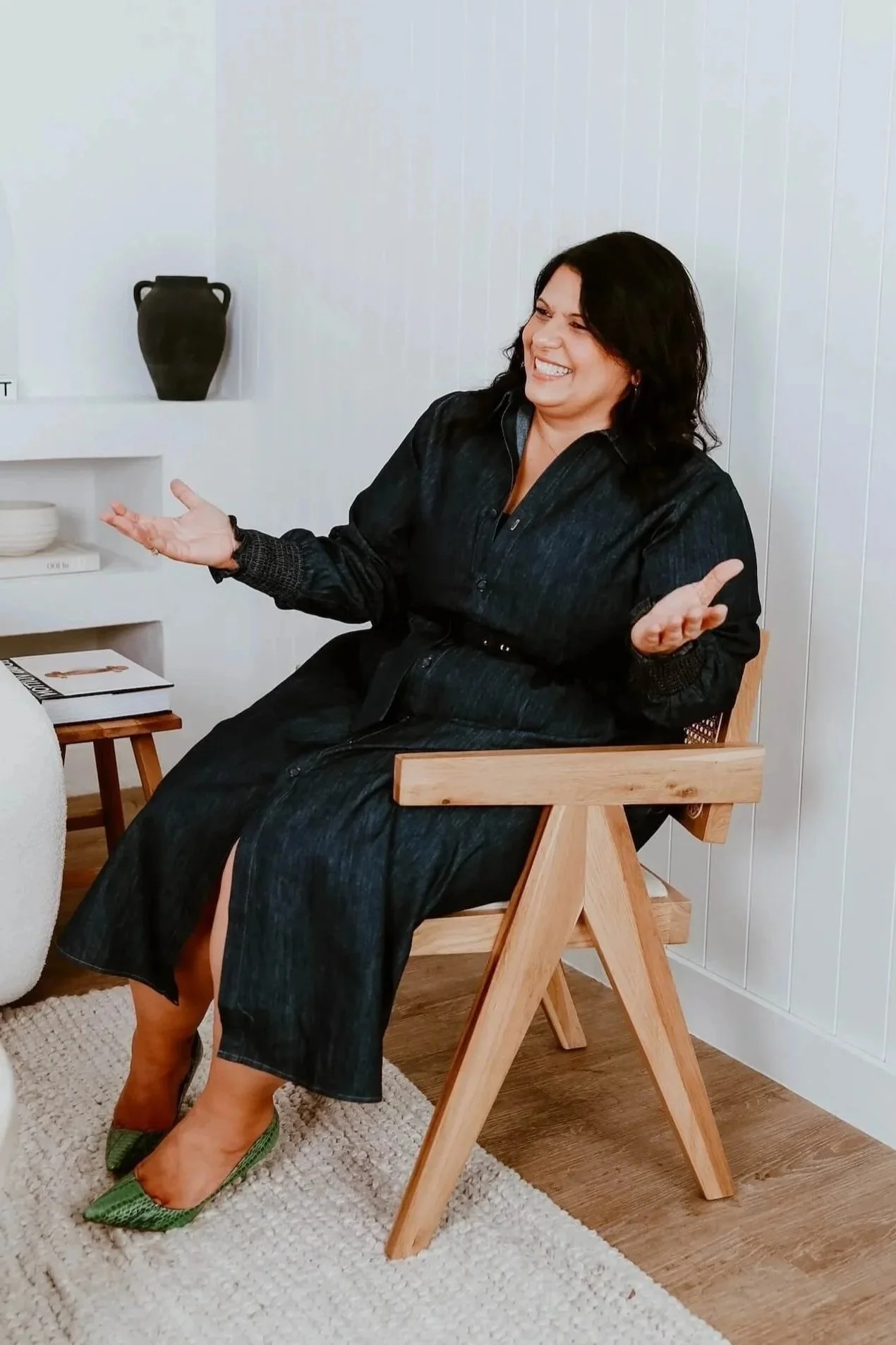Alfina Lofaro, kinesiologist coach educator and author, seated in a warm natural setting