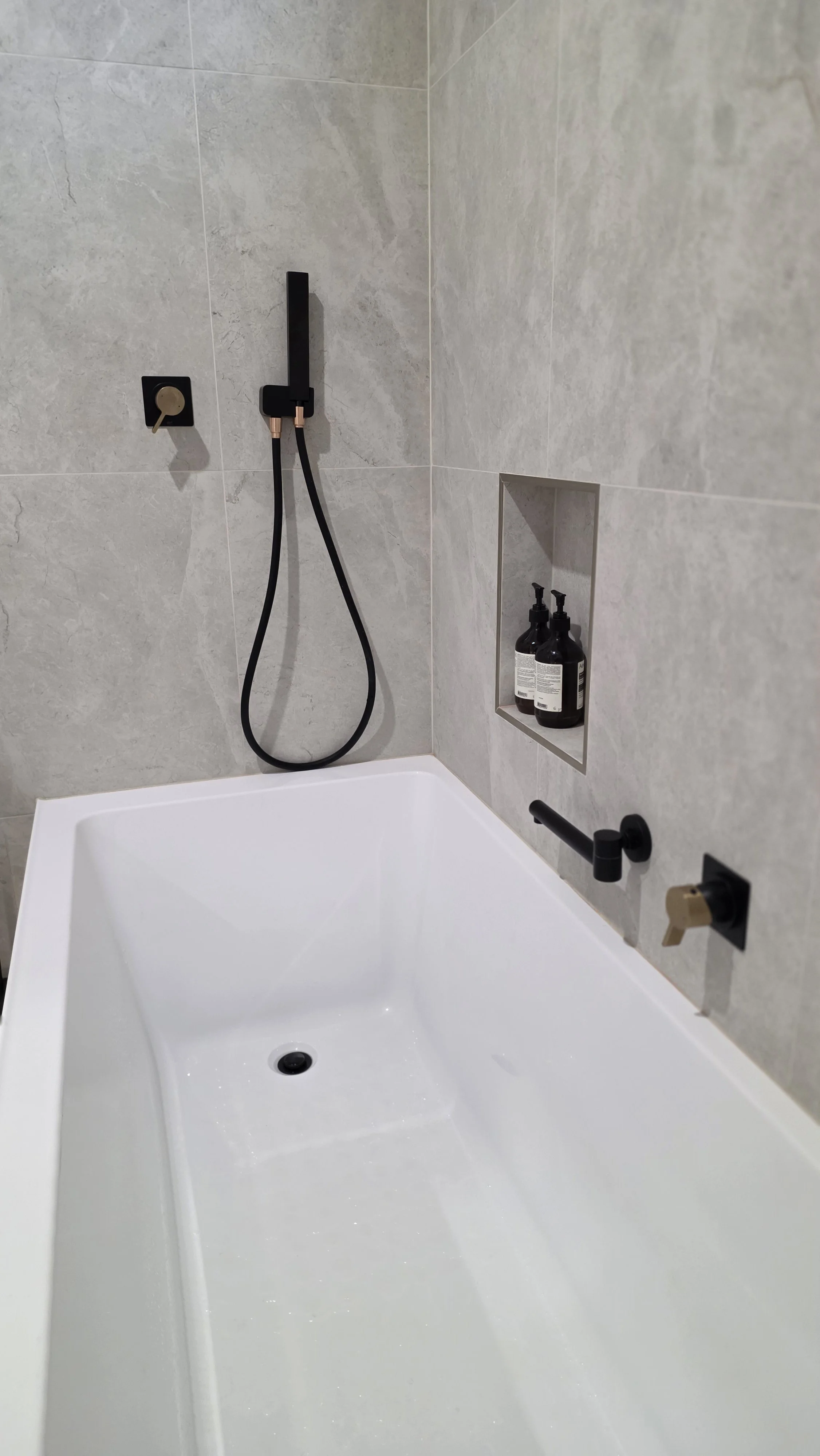 The bathroom also includes a handheld shower, perfect for added convenience after enjoying a relaxing bath.