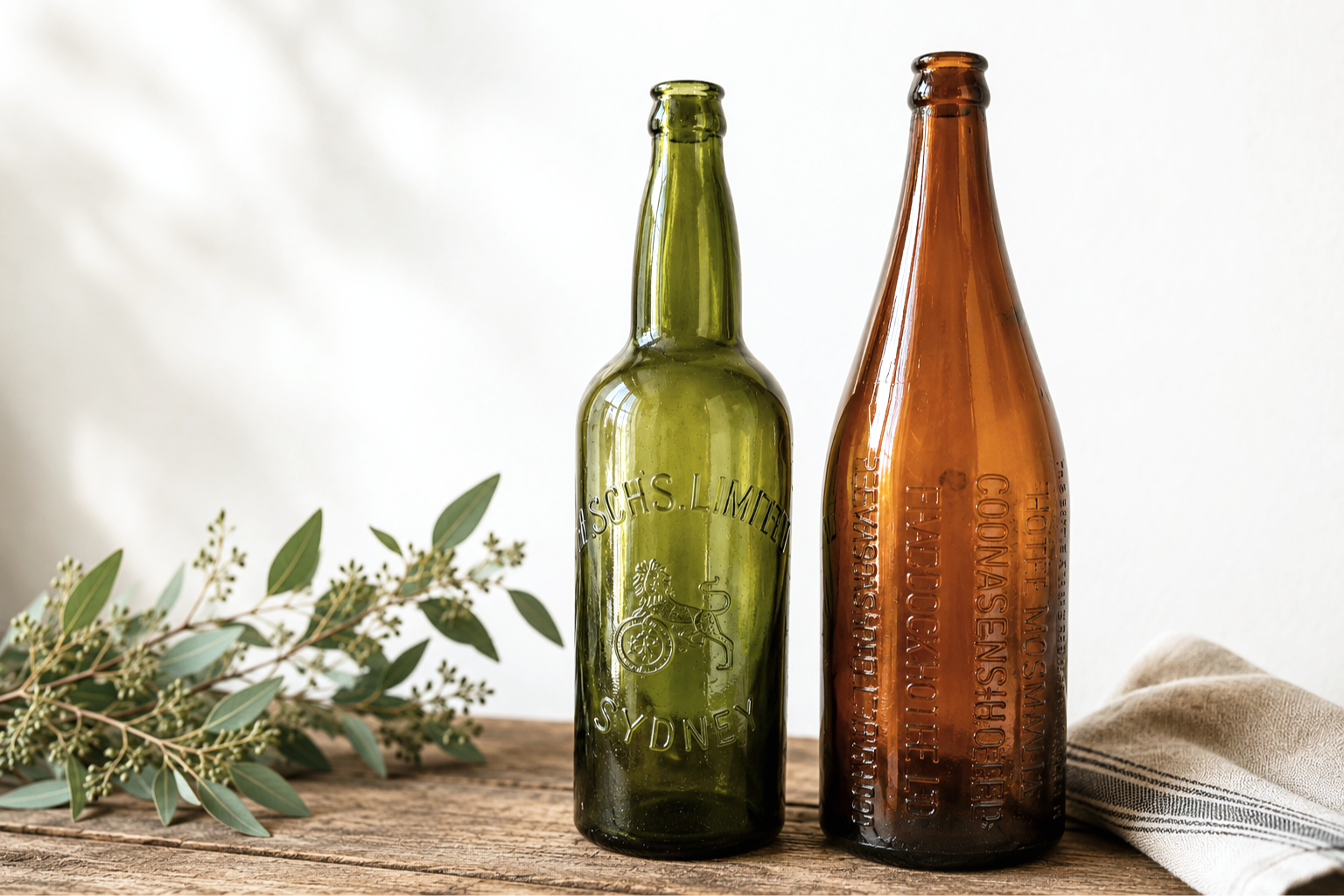 Left: Resch's Limited Sydney beer bottle (green, early 20th century).
Right: Multi-hotel "take-home" quart beer bottle from Hotel Mosman Ltd / Crows Nest Hotel / Five Dock Hotel / Freemasons Hotel (Sydney area).
These reclaimed glass bottles were dis