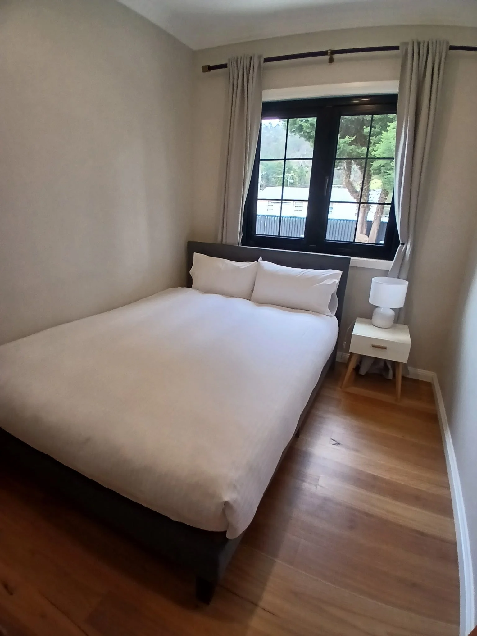Bedroom with a queen bed and clothes rack