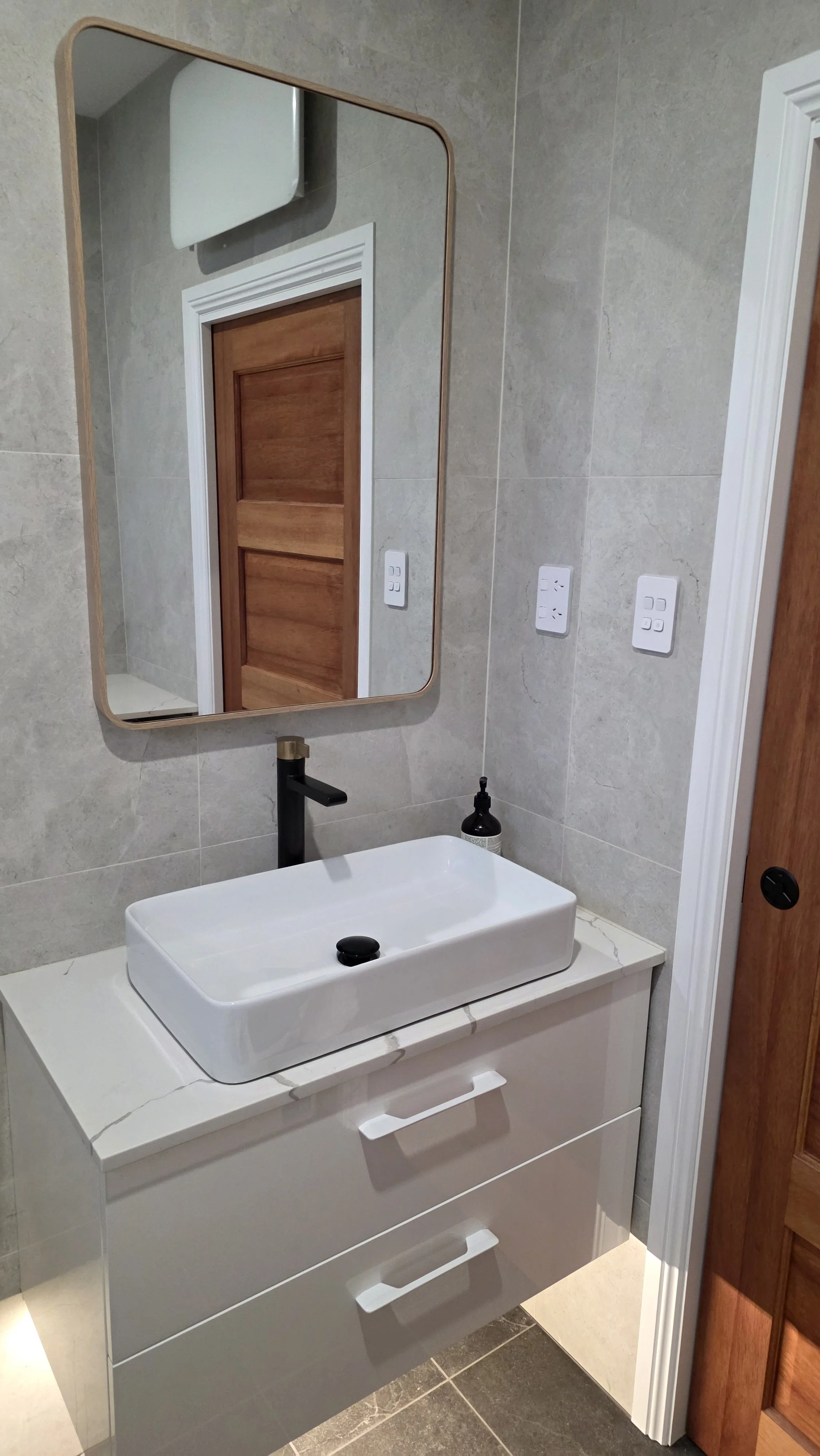 The bathroom also features a large mirror designed to comfortably suit guests of all heights.