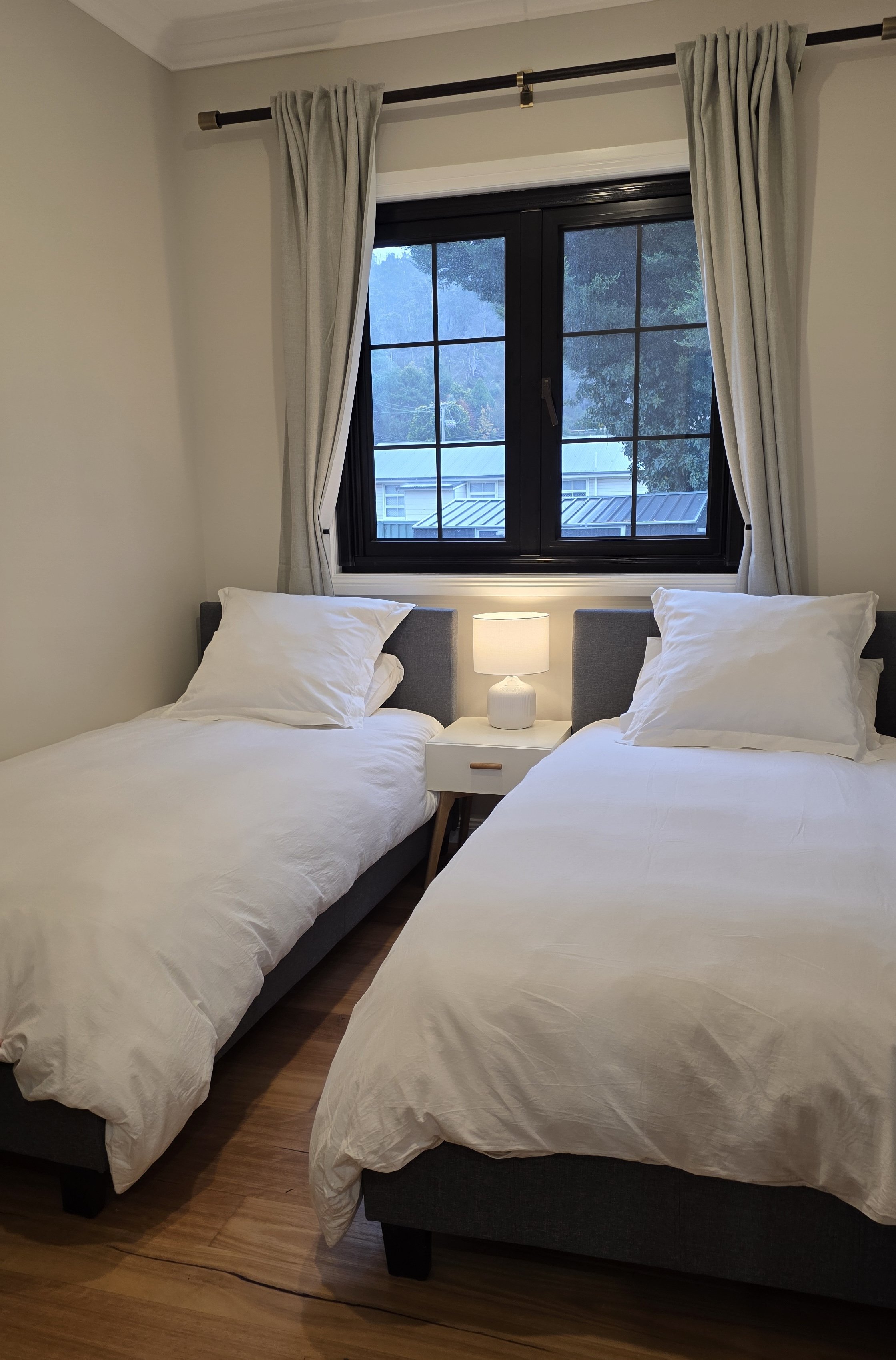 The second bedroom features two comfortable single beds, making it ideal for friends, children, or additional guests.
