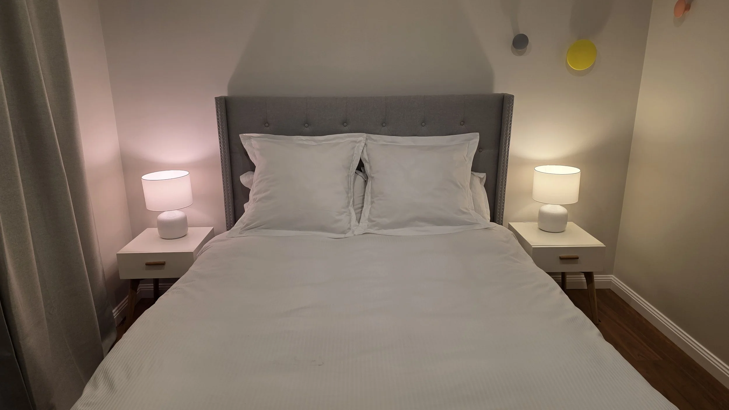 The master bedroom also includes bedside tables and lamps for added comfort and convenience.