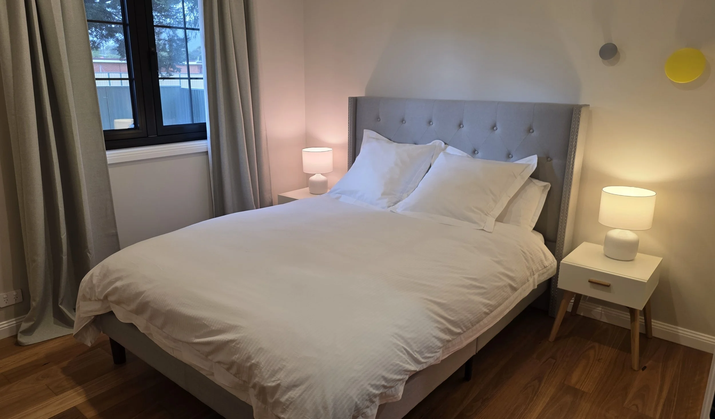 The master bedroom features a queen bed and a clothes rack suitable for two people. This bedroom also includes a private ensuite bathroom.