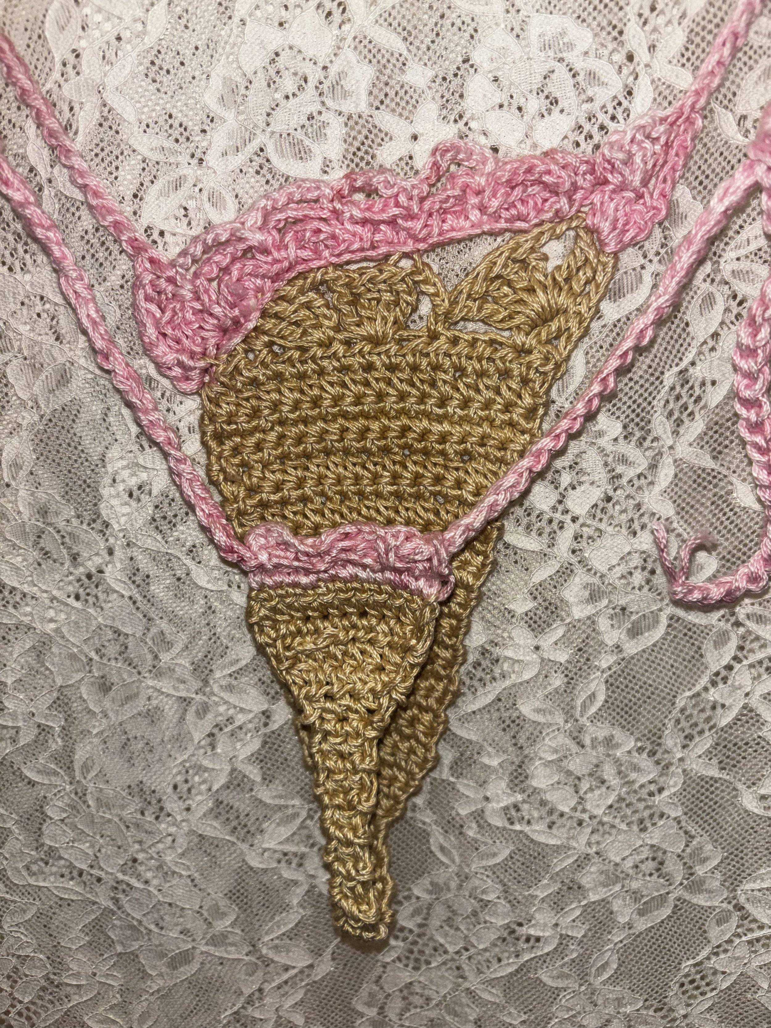 \Cotton crochet bikini bottom. Featuring light green and pink.