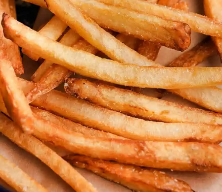Close-up of French fries with a golden-brown crispy appearance.