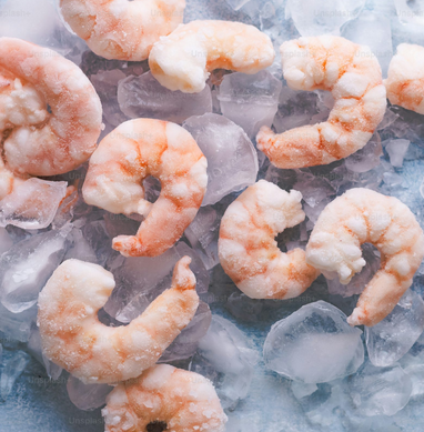 Frozen pink shrimp on ice.