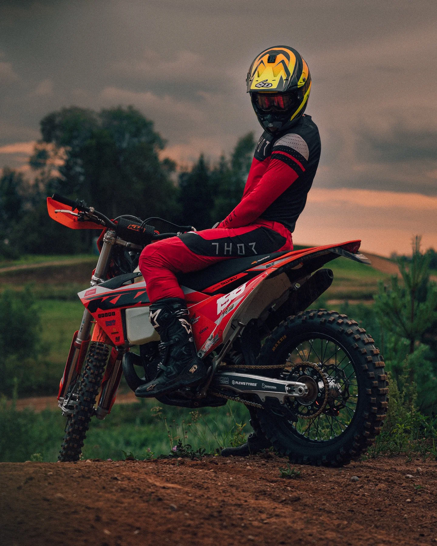motocross-rider-posing-dirtbike-red-gear-sunset-estonia.jpg