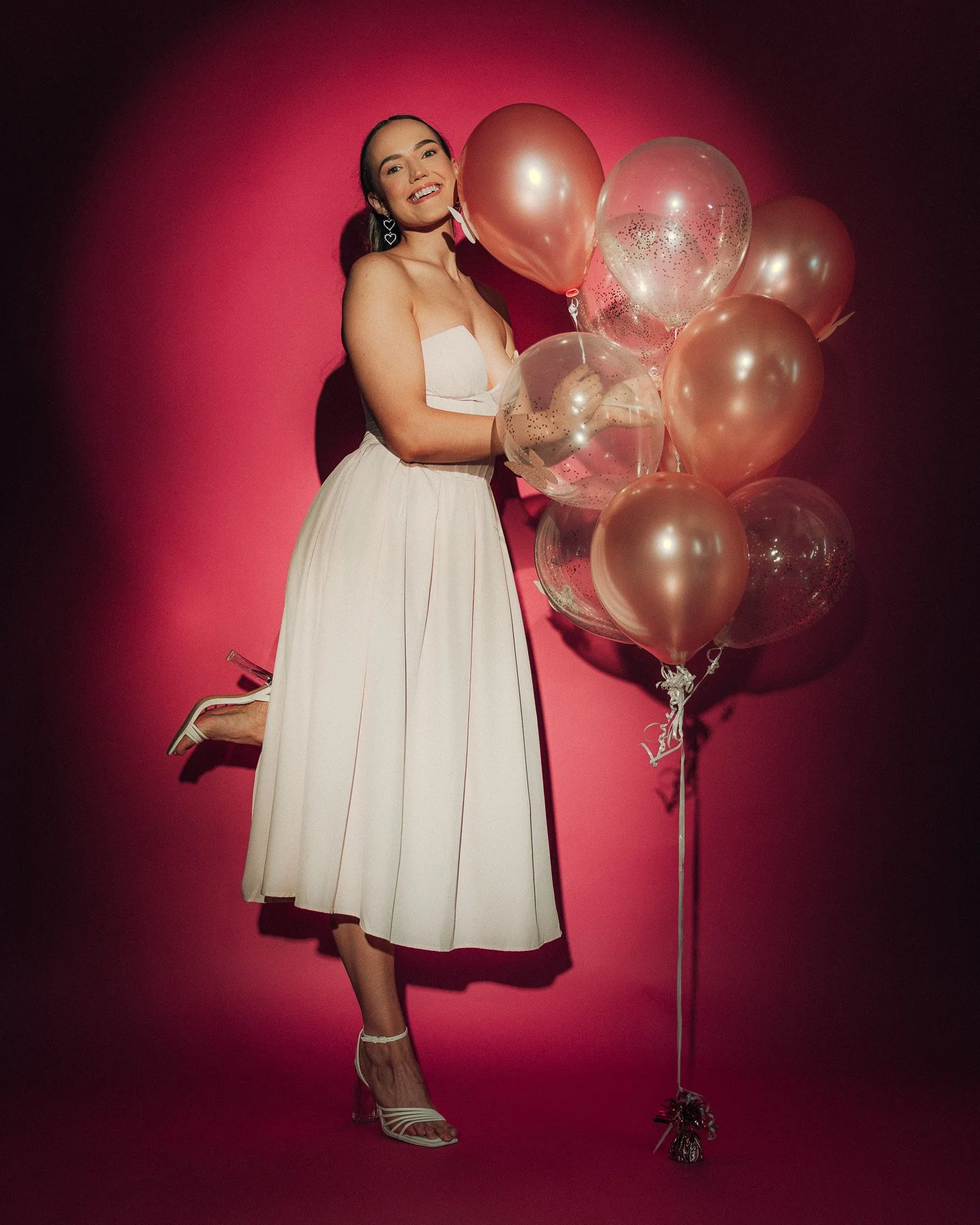 studio-glamour-portrait-woman-white-dress-pink-balloons.jpg