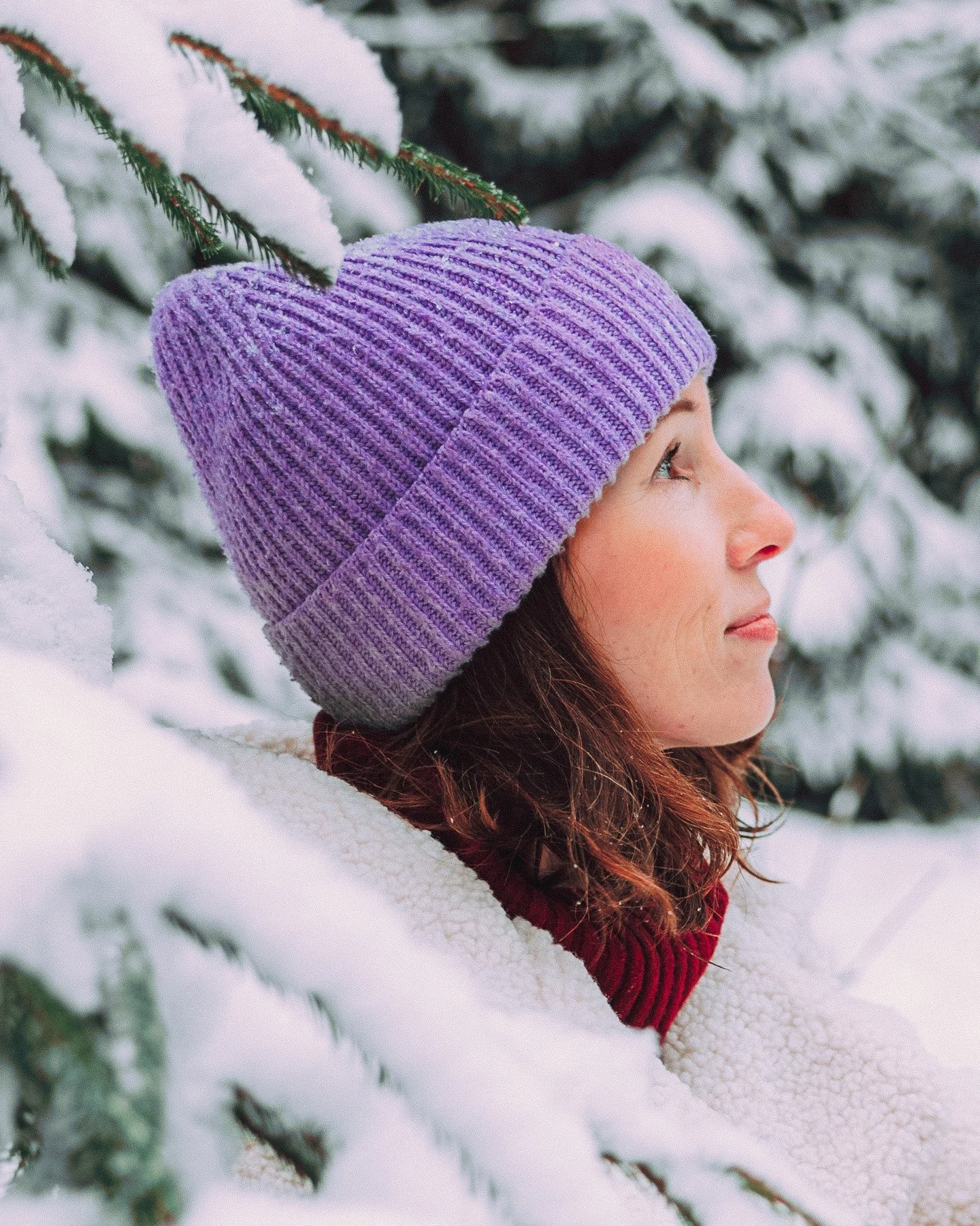 winter-portrait-woman-purple-beanie-snowy-forest.jpg
