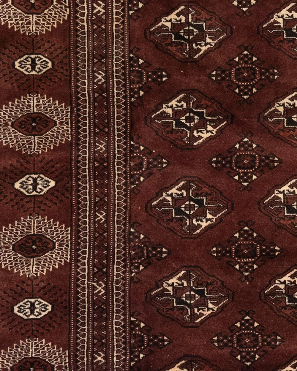 Large Turkoman rug with geometric design in deep aubergine and tobacco brown, 380 × 250 cm