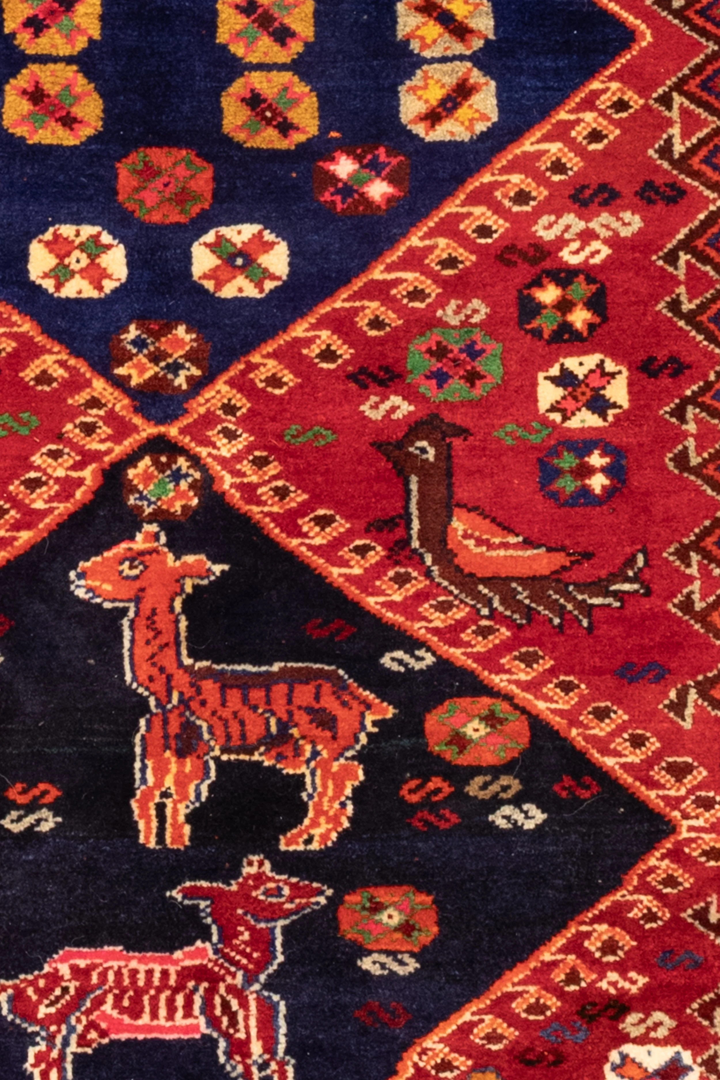 Persian Qashqai 100% wool rug with vibrant tribal design in scarlet, navy, orange and green, 225 × 145 cm
