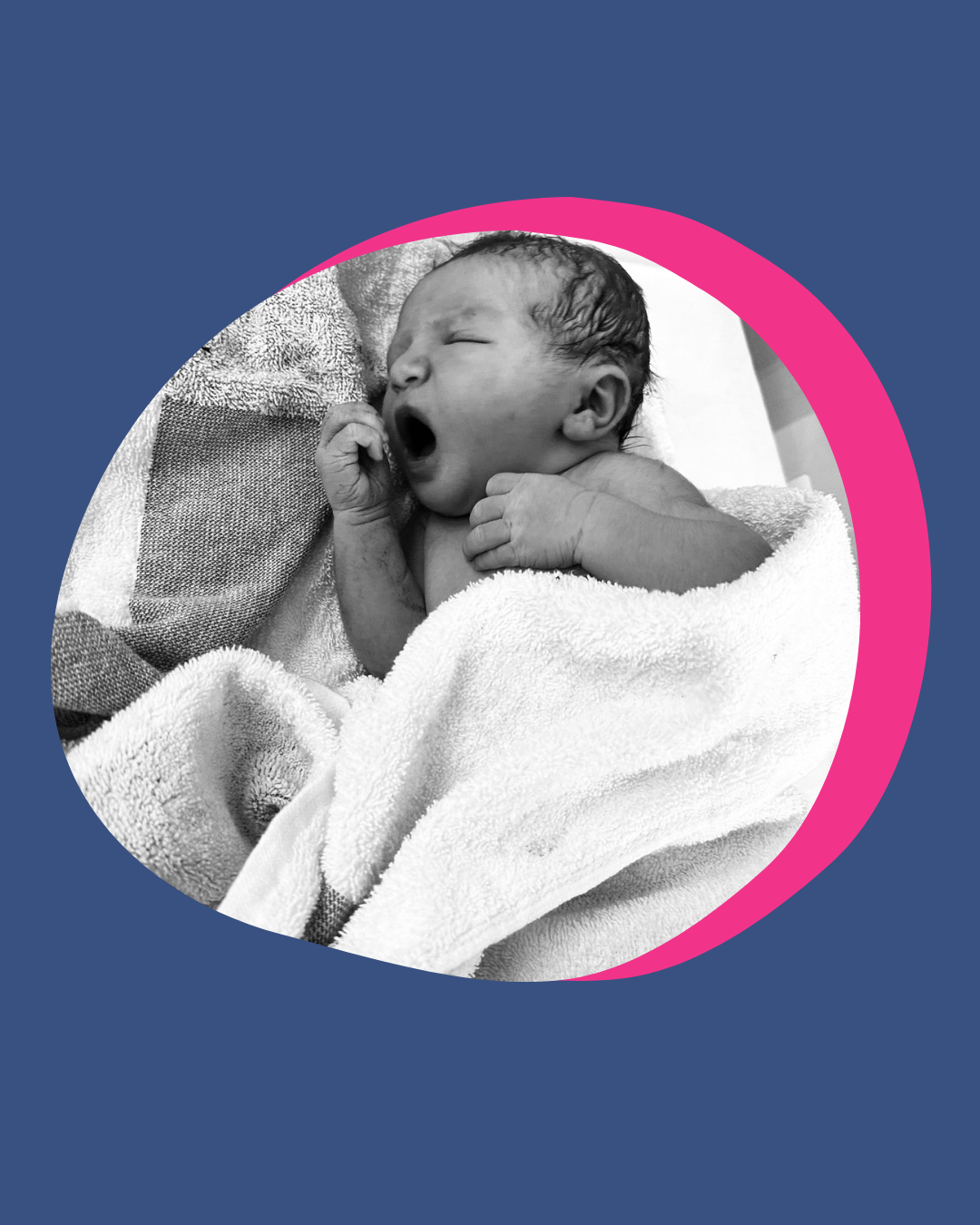 A newborn baby yawns while wrapped in a towel, resting on a blanket.