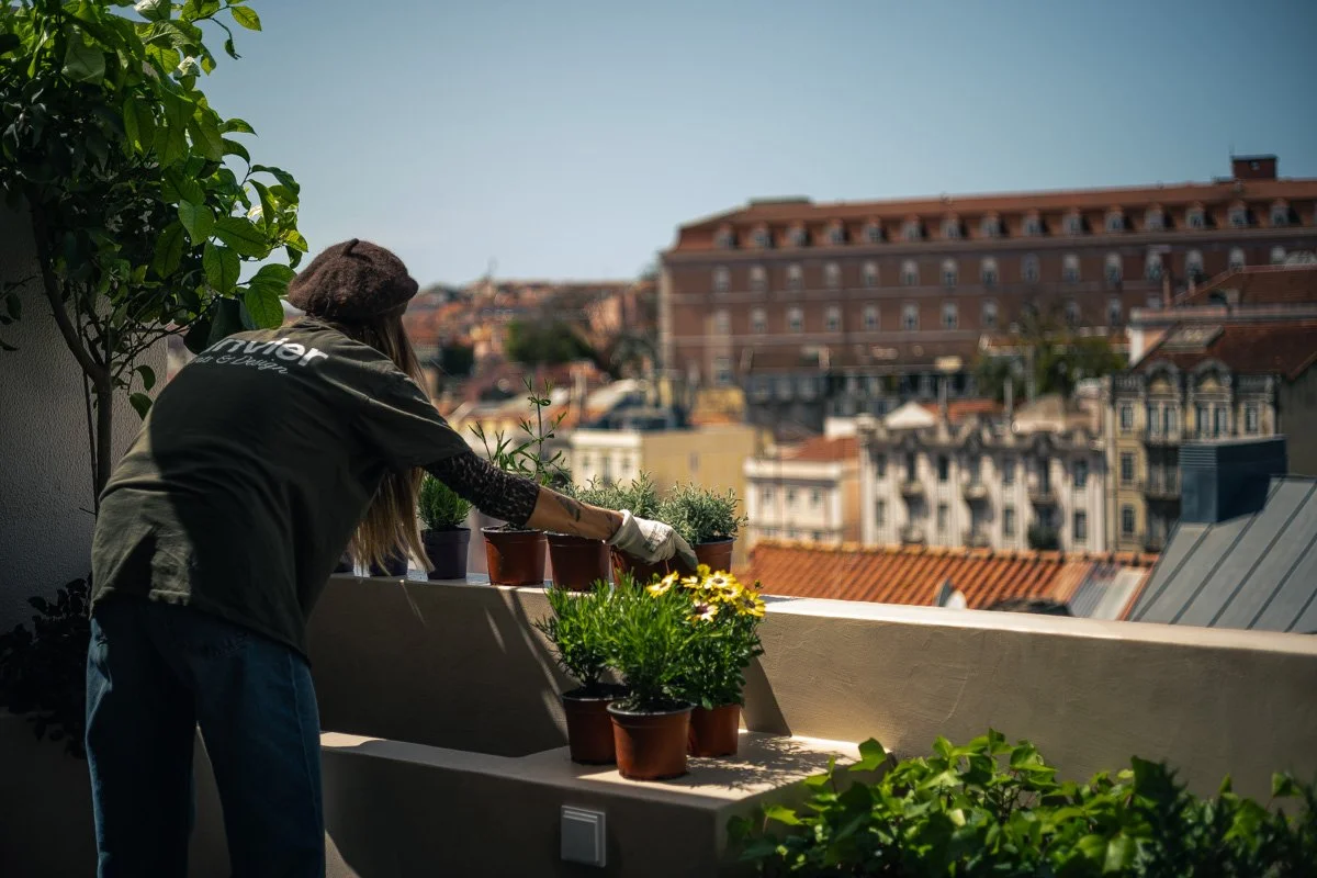 Claire de Fraiteur working on a balcony installation in Lisbon
