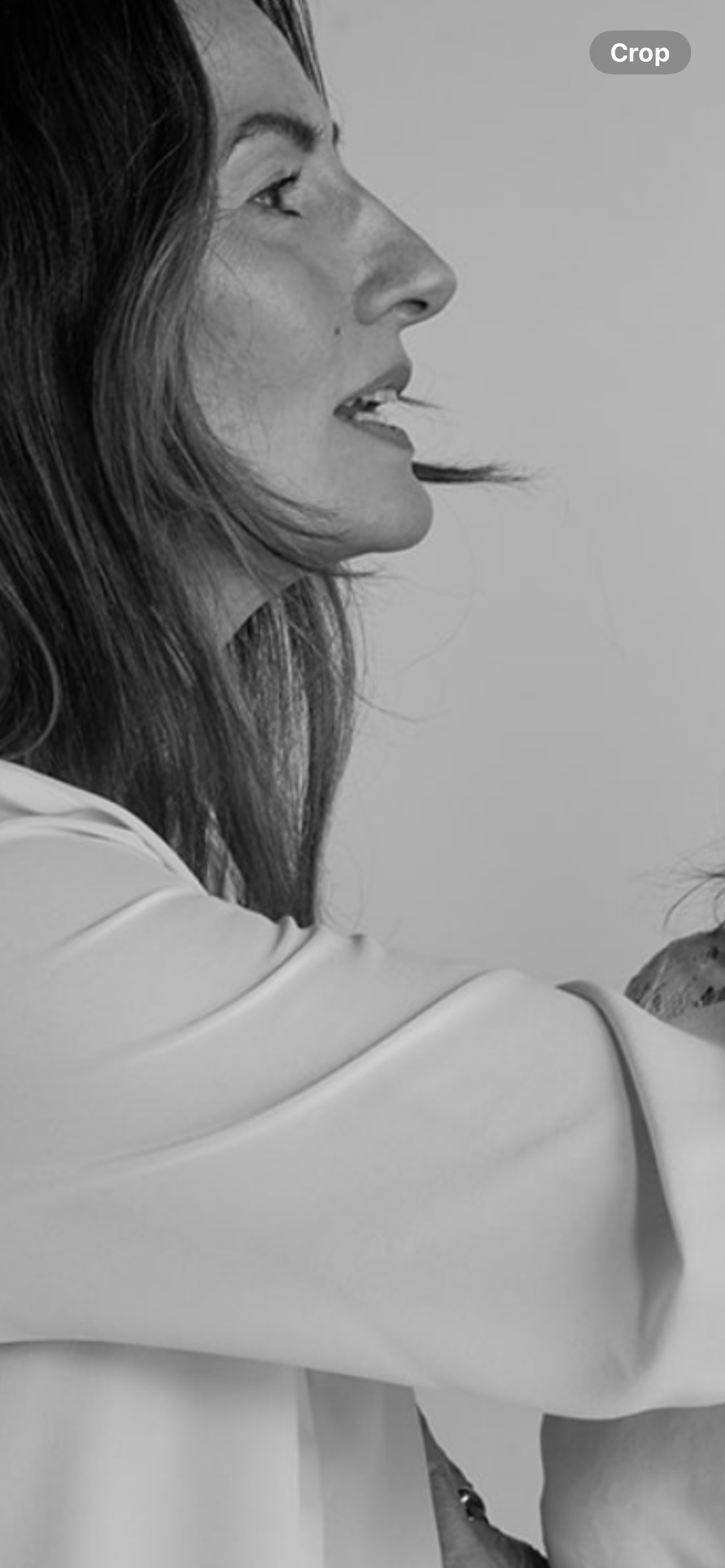 Jayne Cook in profile with long hair and a light-colored shirt, looking to her right.