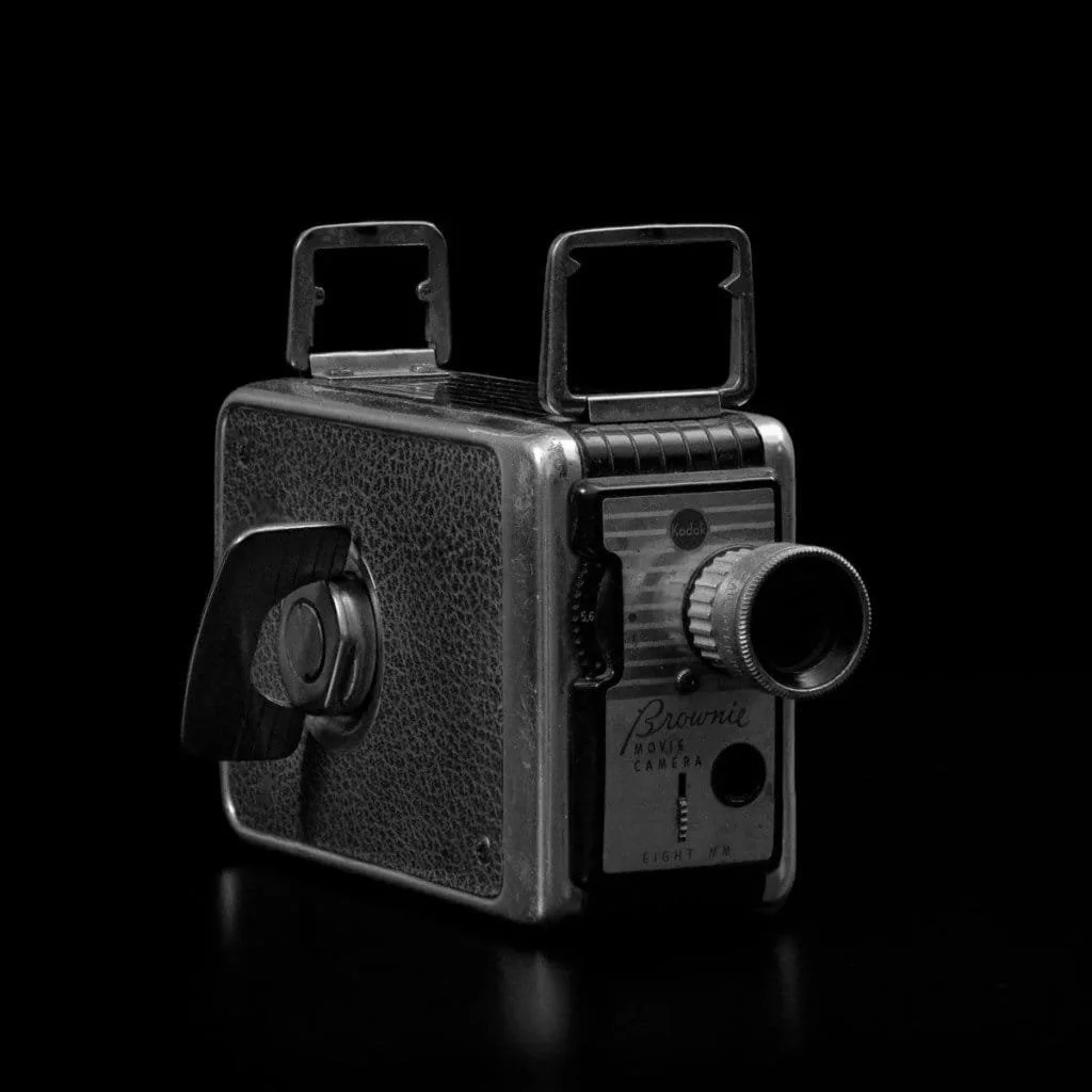 A stacked, black and white image of a vintage camera.