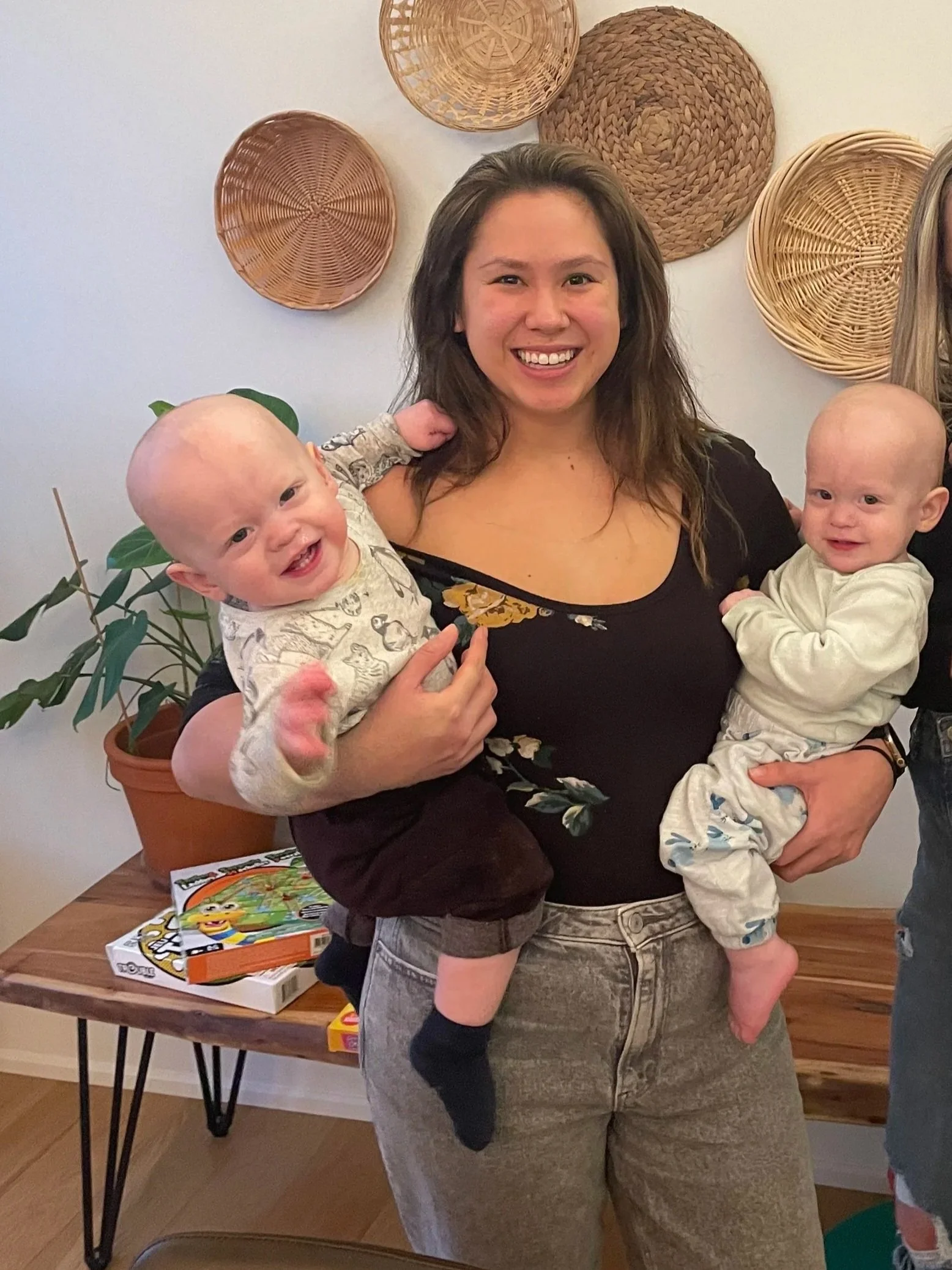 Terri Kwok, Registered Psychotherapist and mother of twins, holding her two babies
