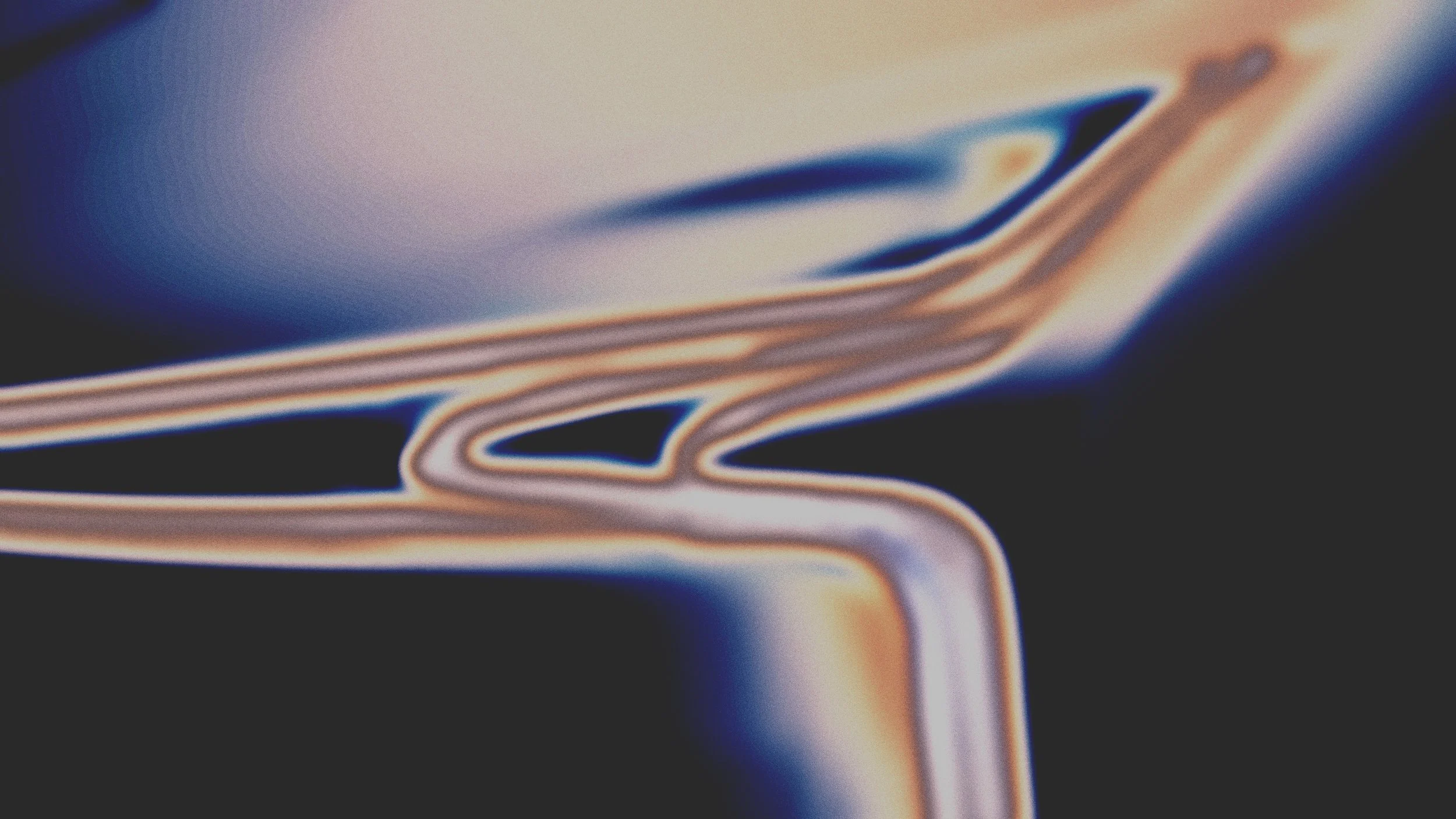 Détails flous avec des lignes brillantes colorées sur un fond sombre.