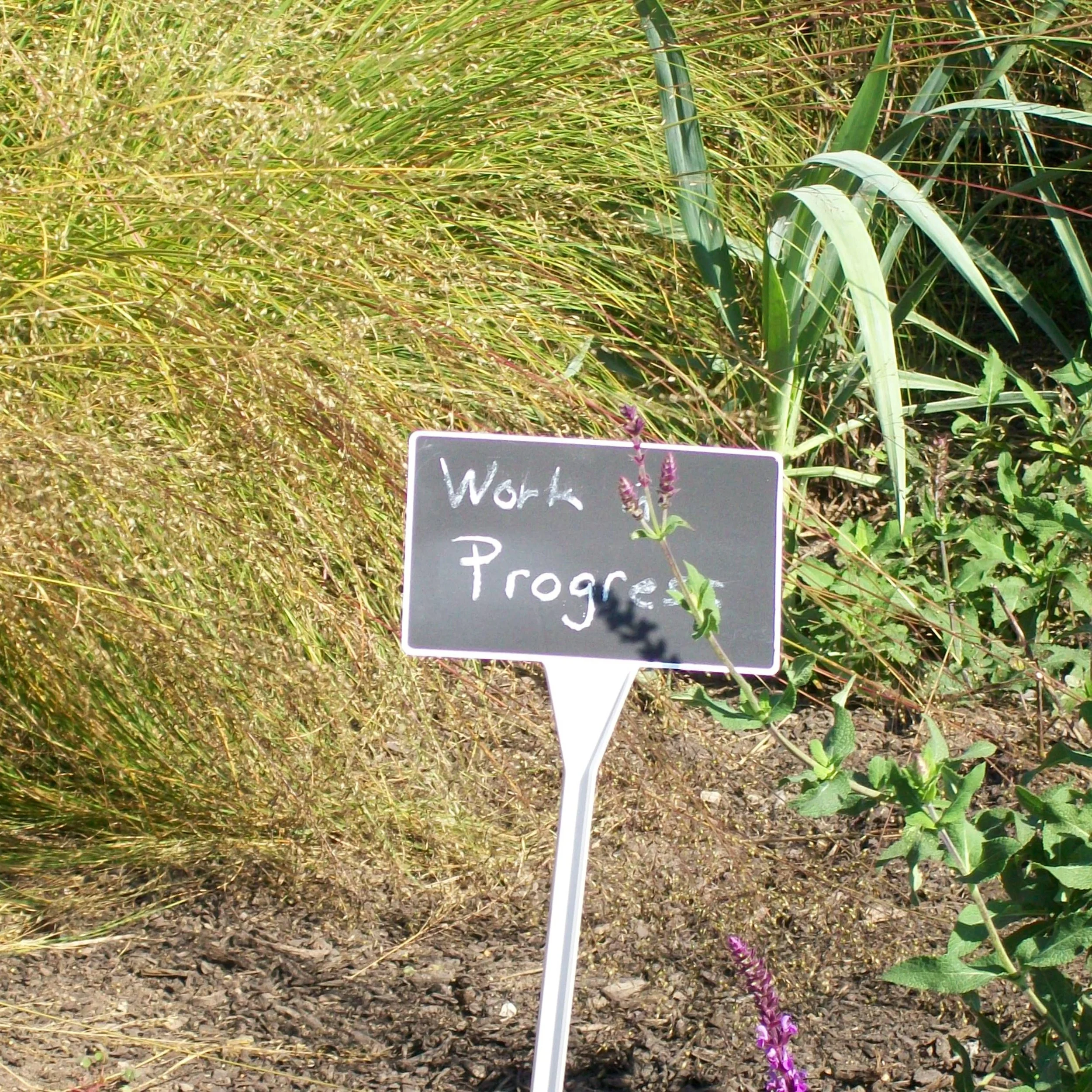 sign Work in Progress with plants