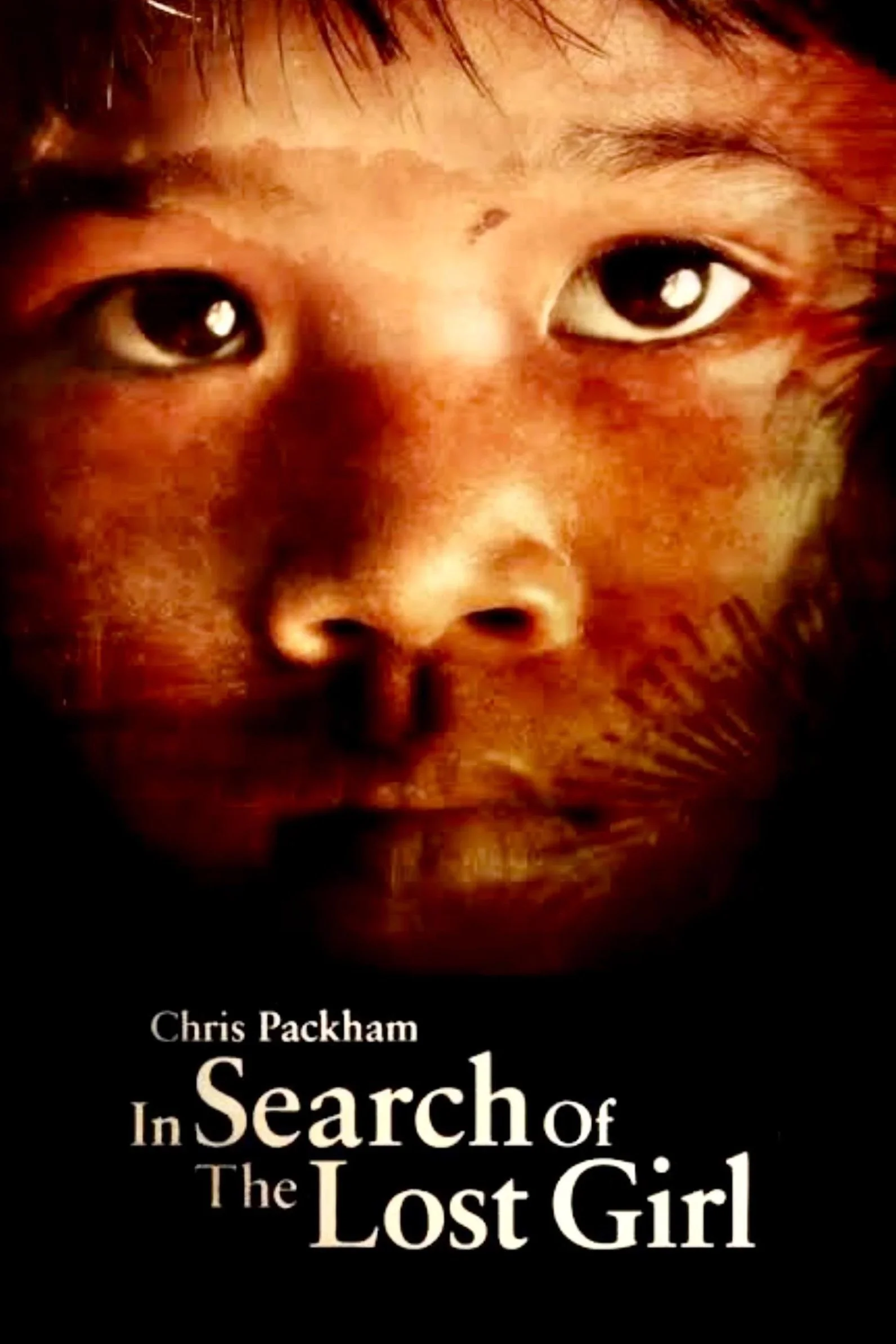 Close-up of a book cover featuring a young girl's face with dark eyes and hair, and the title 'Chris Packham: In Search of the Lost Girl'.