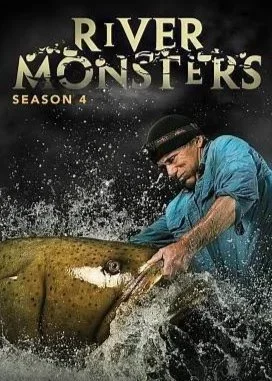 Jeremy Wade in a blue shirt and black hat holding a large fish in a river with splashing water. The series poster for season 4 of River Monsters.