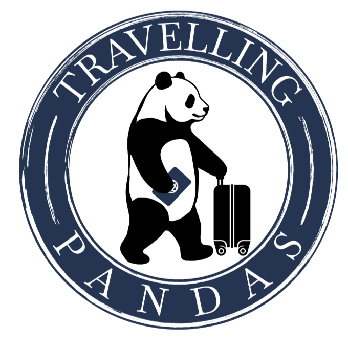 A circular logo with the words "Traveling Pandas" around the border, featuring a panda carrying a suitcase inside the circle.